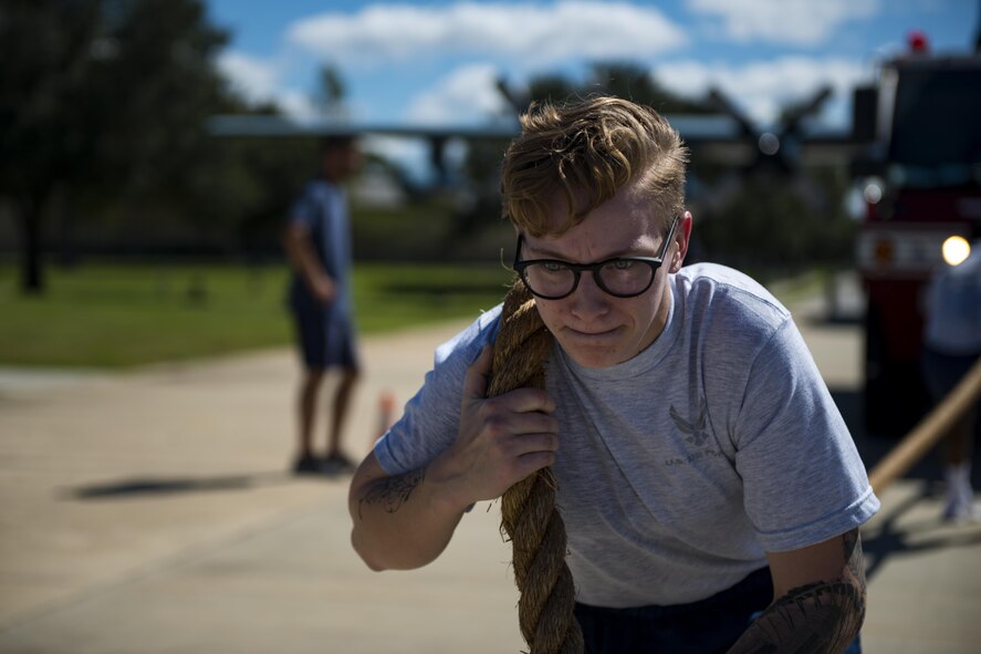 Airman 1st Class Caitlyn Knobbe, 23d Component Maintenance Squadron aerospace propulsion mechanic, pulls a firetruck with her teammates during the 2017 Fire Prevention Week Fire Muster, Oct. 13, 2017, at Moody Air Force Base, Ga. The 23d Civil Engineer Squadron fire department designed the muster to allow teams of Airmen to compete in several events, ranging from a hose roll to a fire truck pull. Event organizers wanted Airmen to experience being a firefighter in a way that got people active. (U.S. Air Force photo by Airman 1st Class Erick Requadt)