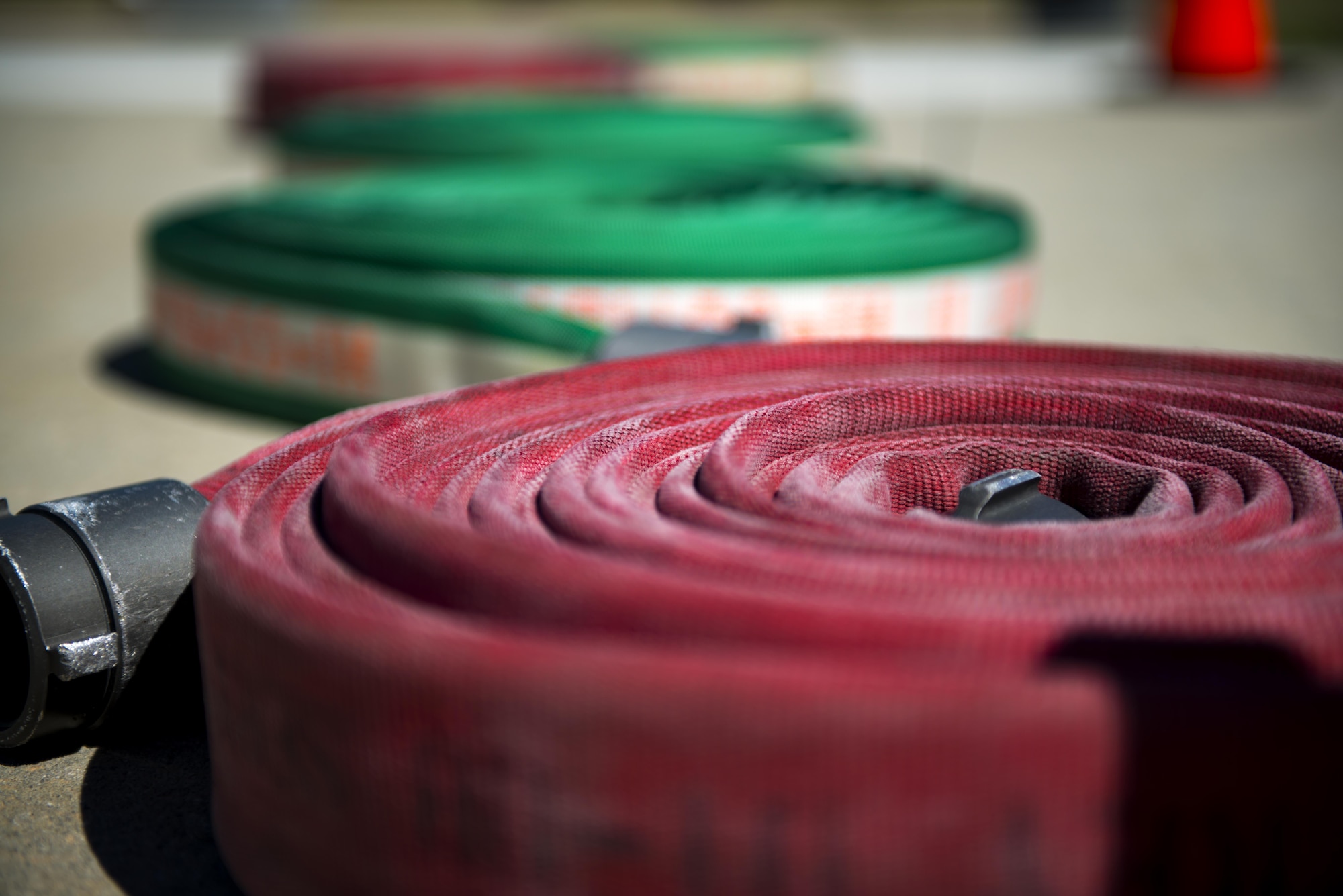 Fire hoses rest on the ground during the 2017 Fire Prevention Week Fire Muster, Oct. 13, 2017, at Moody Air Force Base, Ga. The 23d Civil Engineer Squadron fire department designed the muster to allow teams of Airmen to compete in several events, ranging from a hose roll to a fire truck pull. Event organizers wanted Airmen to experience being a firefighter in a way that got people active. (U.S. Air Force photo by Airman 1st Class Erick Requadt)