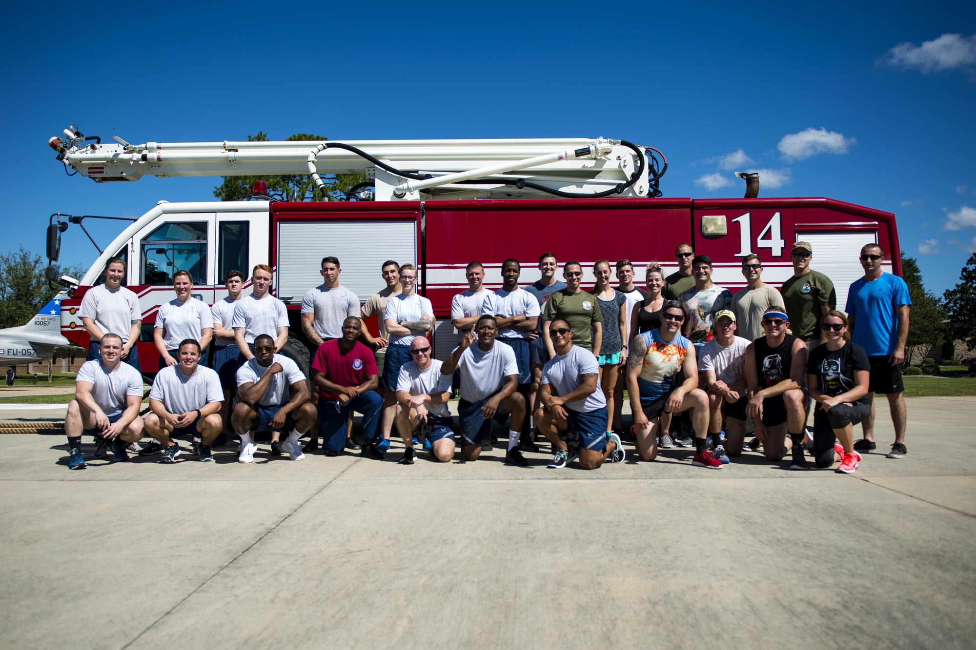 Participants of the 2017 Fire Prevention Week Fire Muster pose for a picture, Oct. 13, 2017, at Moody Air Force Base, Ga. The 23d Civil Engineer Squadron fire department designed the muster to allow teams of Airmen to compete in several events, ranging from a hose roll to a fire truck pull. Event organizers wanted Airmen to experience being a firefighter in a way that got people active. (U.S. Air Force photo by Airman 1st Class Erick Requadt)