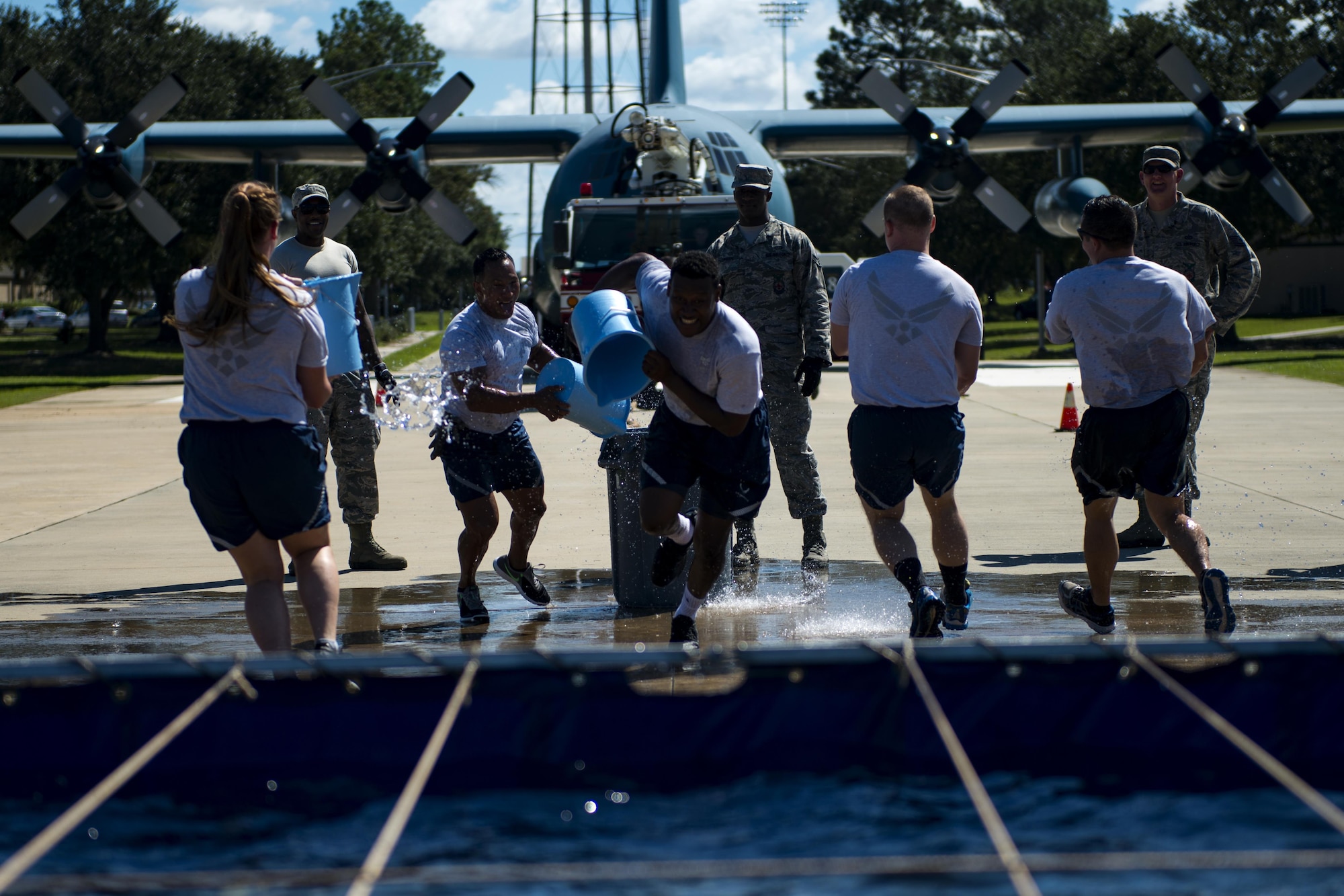 Airmen assigned to the 23d Security Force Squadron run to fill a trash can with water in the “bucket brigade” event during the 2017 Fire Prevention Week Fire Muster, Oct. 13, 2017, at Moody Air Force Base, Ga. The 23d Civil Engineer Squadron fire department designed the muster to allow teams of Airmen to compete in several events, ranging from a hose roll to a fire truck pull. Event organizers wanted Airmen to experience being a firefighter in a way that got people active. (U.S. Air Force photo by Airman 1st Class Erick Requadt)