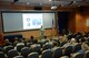 Col. Steven N. Dickerson, commander of the 557th Weather Wing, gives a mission brief to service members and spouses at the Spouses' Event held by the wing at Offutt Air Force Base, Nebraska, Oct. 3, 2017. The event was designed to give spouses a deeper understanding of the weather mission.