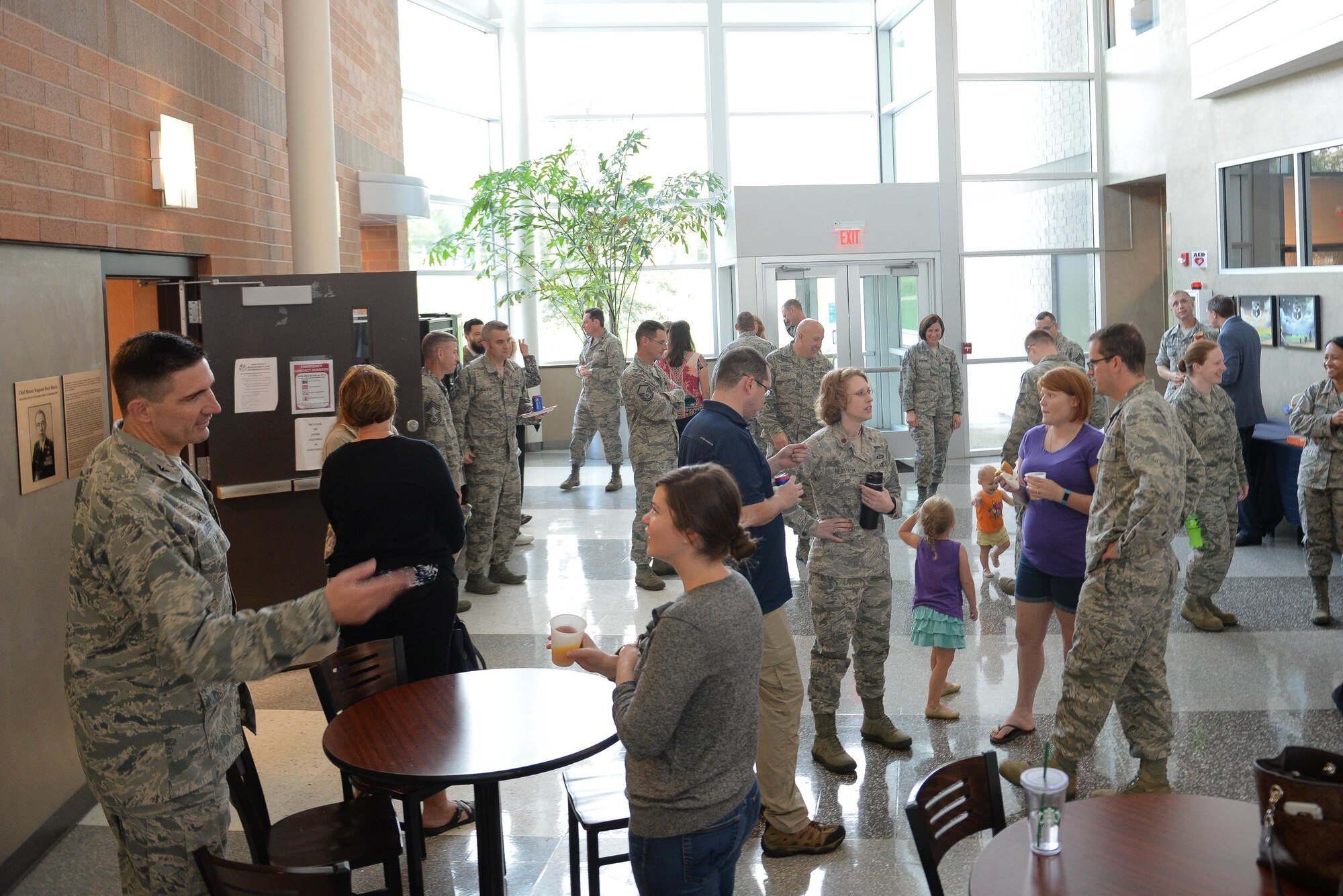 Service members and spouses mingle together at the Spouses' Event held by the 557th Weather Wing at Offutt Air Force Base, Nebraska, Oct. 3, 2017. The event was designed to give spouses a deeper understanding of the weather mission.