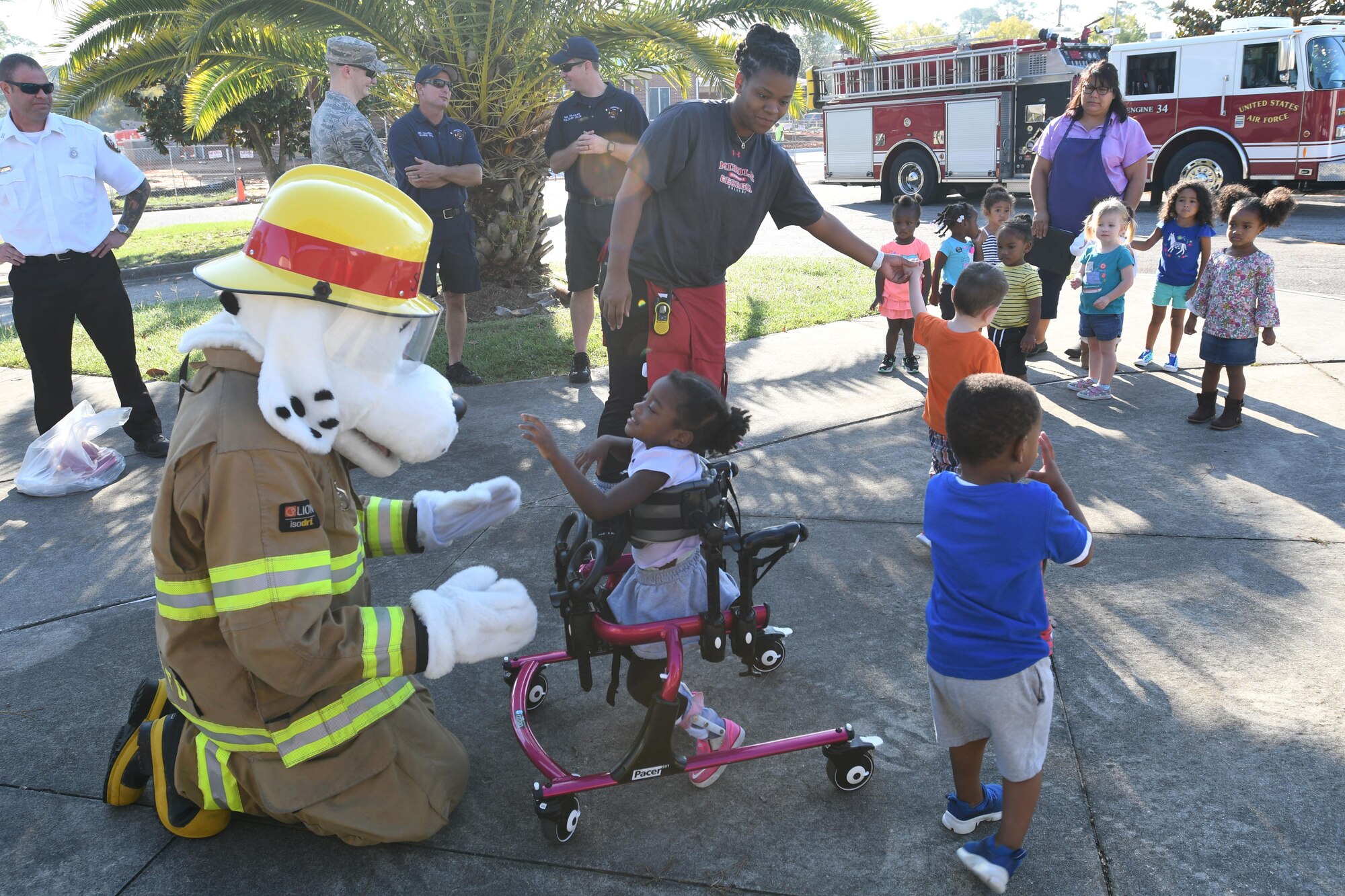 Keesler Child Development Center children meet Sparky the Fire Dog during a Fire Prevention Week demonstration at the CDC Oct. 11, 2017, on Keesler Air Force Base, Mississippi. The week-long event included fire drills, literature handouts, stove fire demonstrations around the base and concluded with an open house at the fire department. (U.S. Air Force photo by Kemberly Groue)