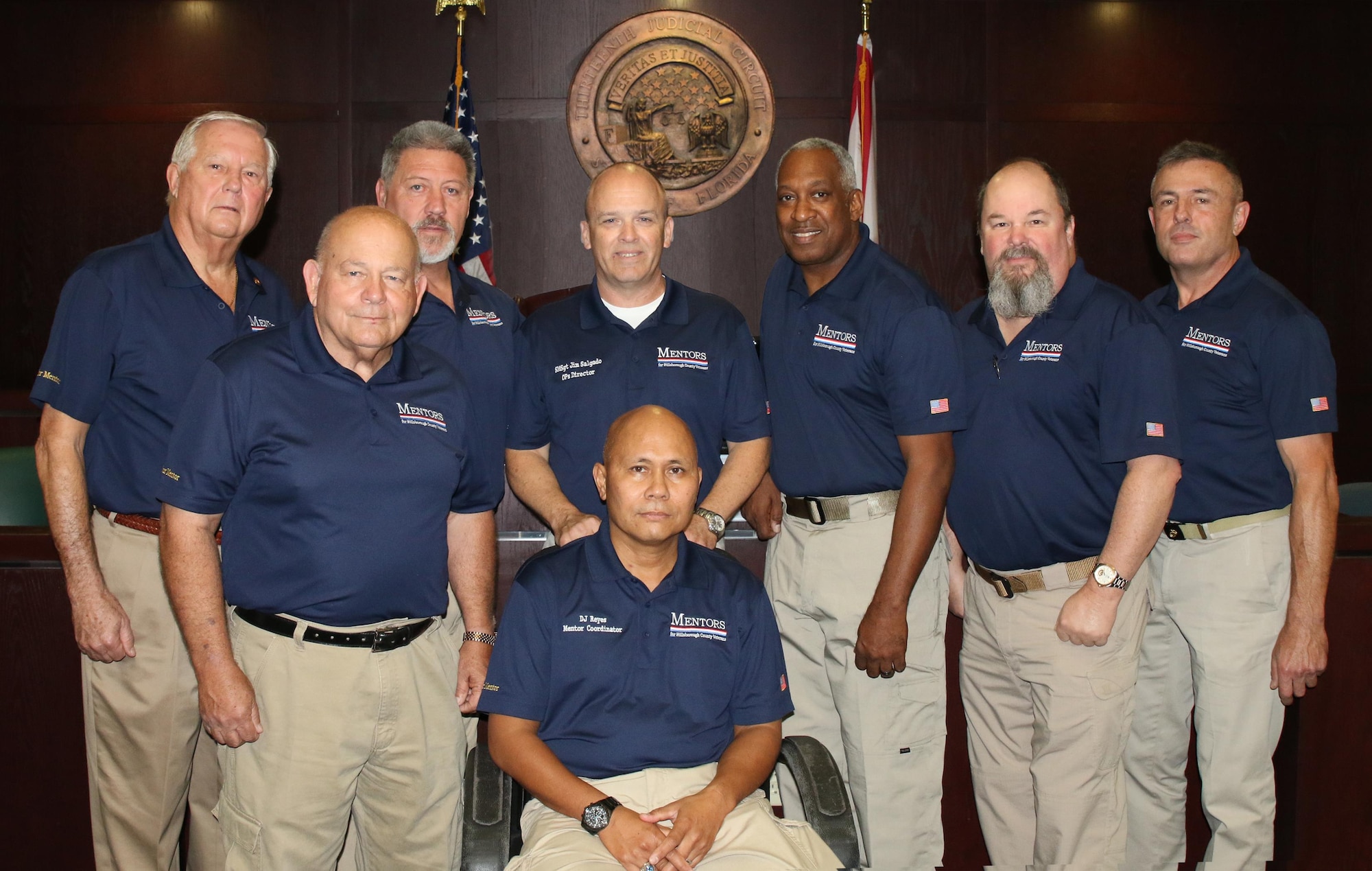 Senior Master Sgt. James Salgado (center, standing) and retired U.S. Army Col. D.J. Reyes (center, seated) with their team of Veterans Treatment Court mentors.