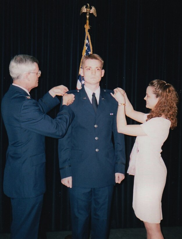 Col. David Miller, 341st Maintenance Group commander, center, pins on the rank of second lieutenant in 1998.