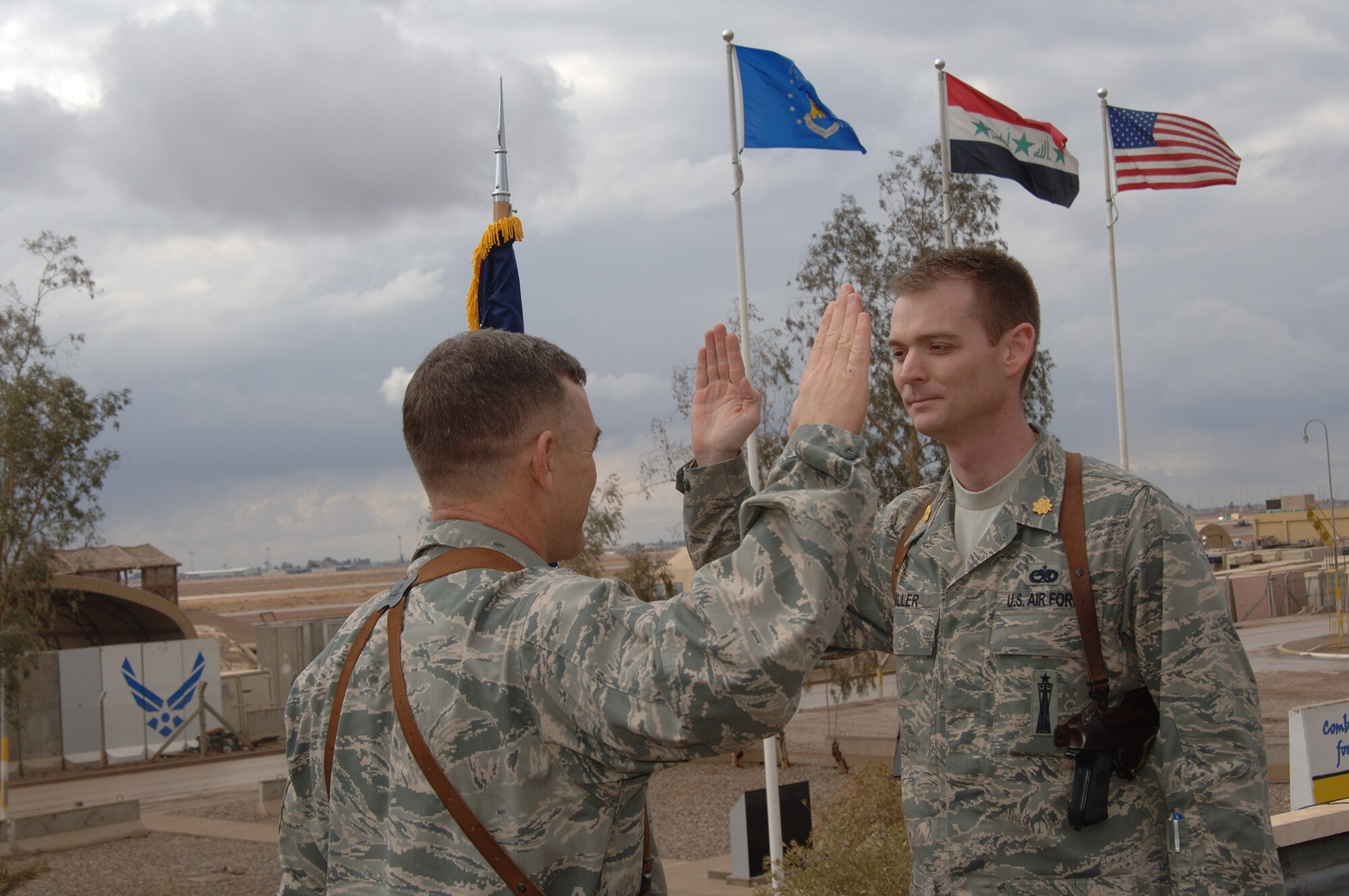Then Maj. David Miller recites the oath of office during a ceremony after pinning on the rank of major at Balad Air Base, Iraq, in 2008.