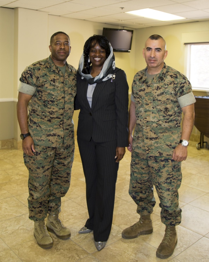 Mildred Muhammad, former wife of the "DC Sniper", John Muhammad, and a survivor of domestic violence, poses with Col. Sekou Karega, commanding officer, and Sgt. Major Sergio MartinezRuiz, base sergeant major, after a speaking engagement aboard Marine Corps Logistics Base Barstow, Calif., Oct. 11. Muhammad's compelling story riveted the audience with details of abuse, child kidnapping, stalking, threats to her life, and eventually the killing of innocent people as a ruse to cover his real plan: To find and kill her.