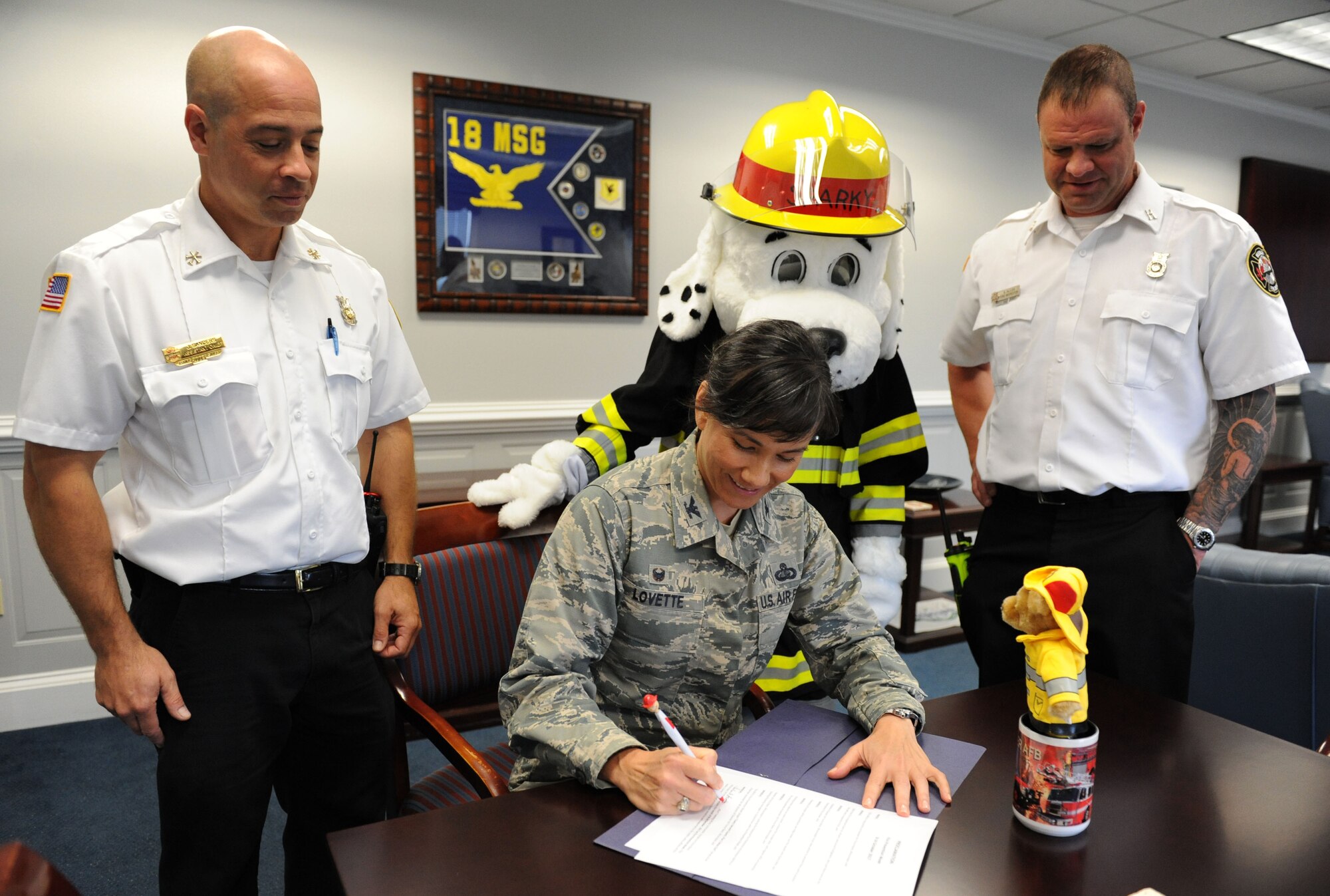 Col. Debra Lovette, 81st Training Wing commander, signs the Fire Prevention Week Declaration at the 81st TRW headquarters building Oct. 10, 2017, on Keesler Air Force Base, Mississippi. The week-long event includes fire drills, literature handouts, stove fire demonstrations around the base and concludes with an open house at the fire department Oct. 14. (U.S. Air Force photo by Kemberly Groue)