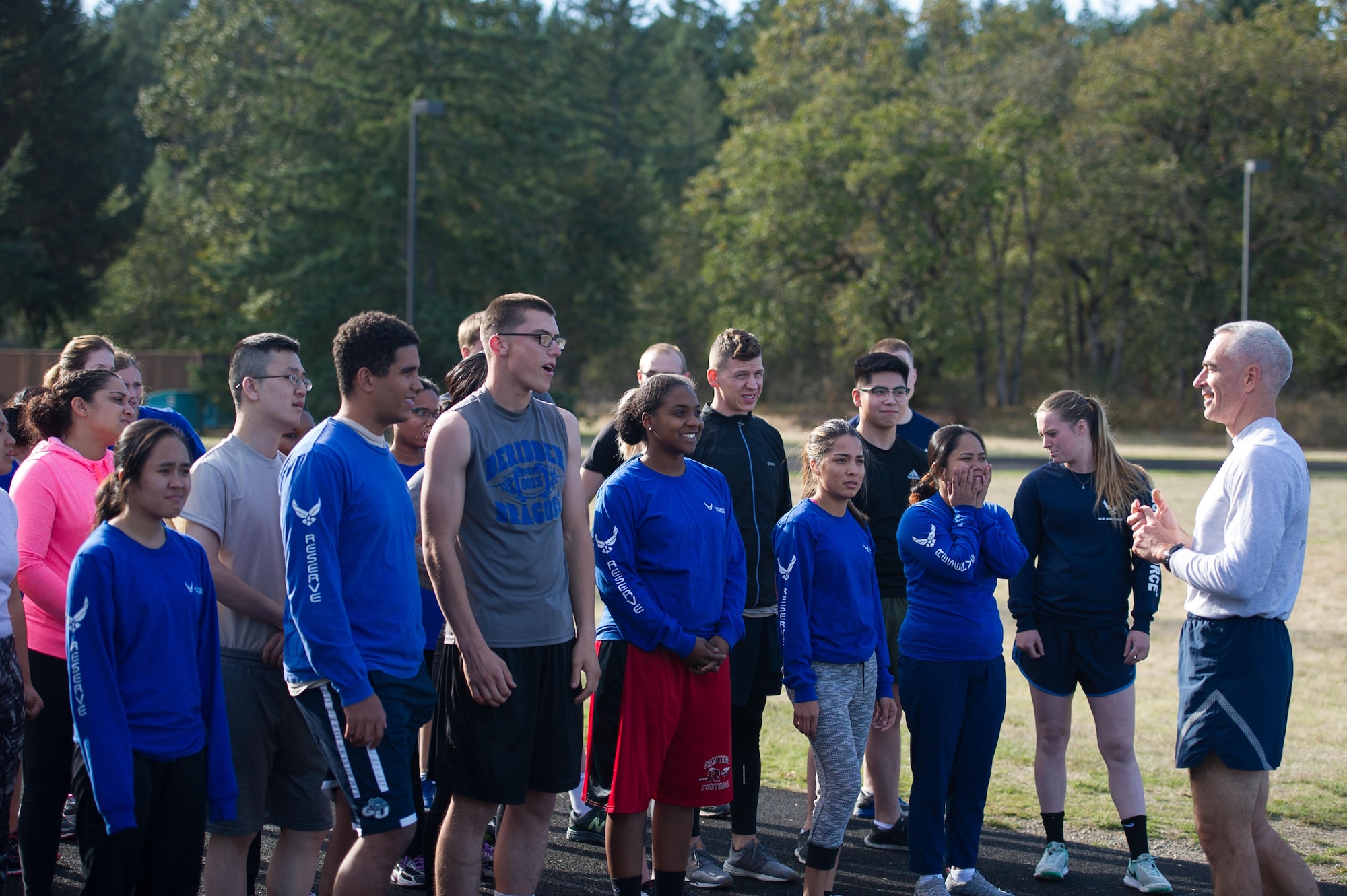 Members of the Development and Training Flight listen to Master Sgt. Edward Callahan, 446th Mission Support Group Career Assistance advisor, instruct their physical training session at the McChord Field track Oct. 15. (U.S. Air Force photo by 1st Lt. Alyssa Hudyma)