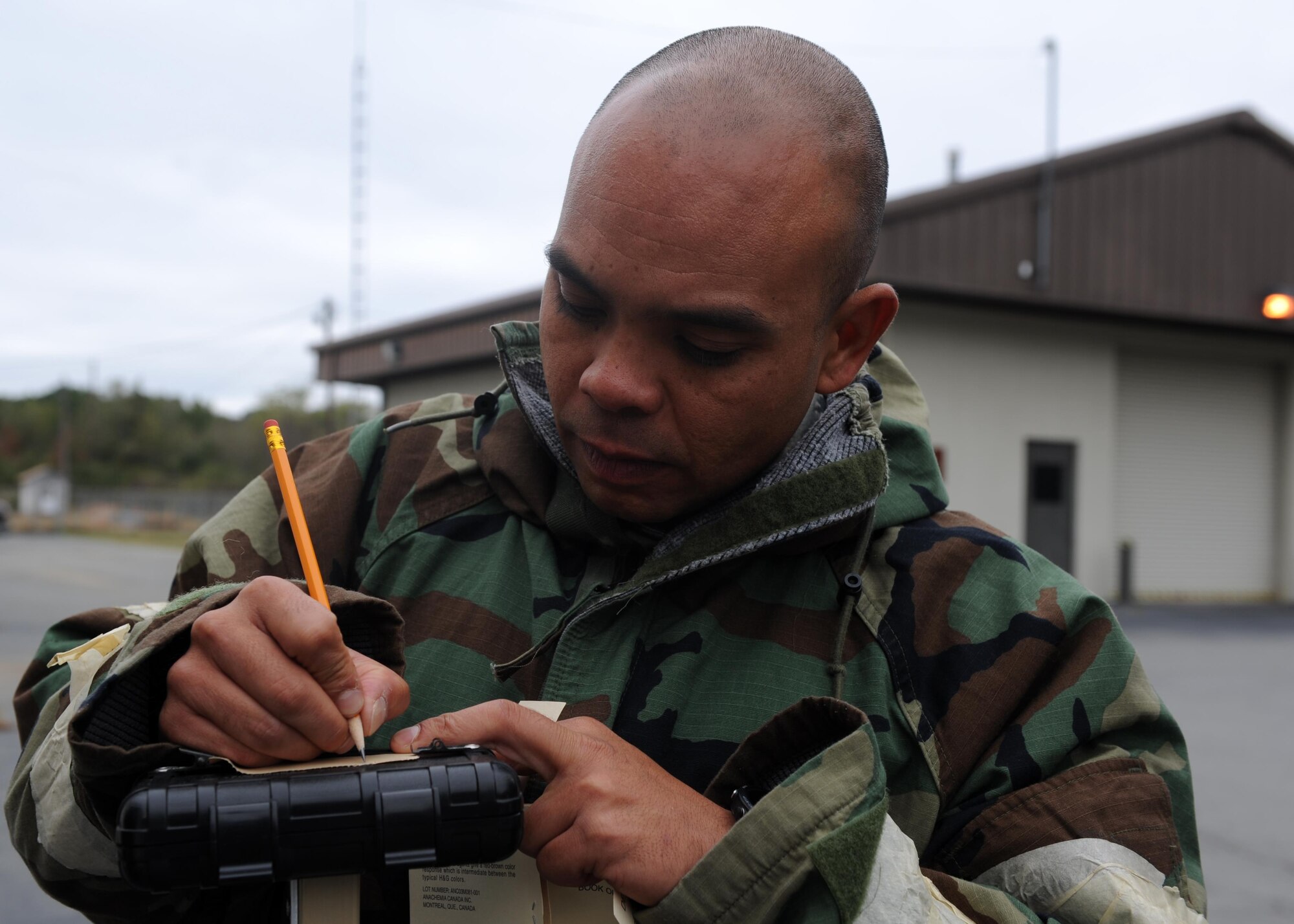 Master Sgt. Michael Kumiyama, 19th Force Support Squadron career assistance advisor, fills out M8 paper to identify chemical contaminants during Chemical, Biological, Radiological, Nuclear and high-yield Explosives training Oct. 10, 2017, at Little Rock Air Force Base, Ark. The training teaches Airmen how to survive and operate in hazardous environments whether deployed or at home station. (U.S. Air Force photo by Airman 1st Class Grace Nichols)