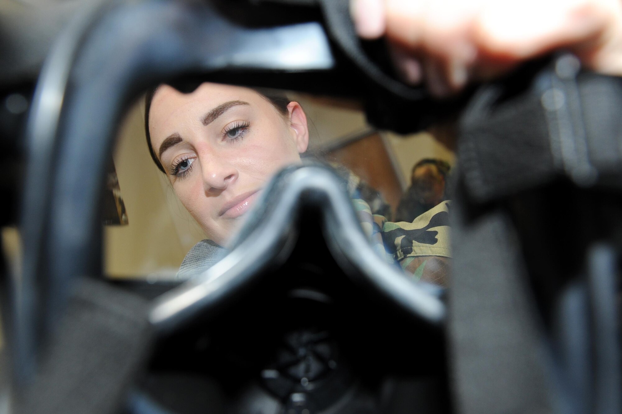Tech. Sgt. Amber Montanaro, 19th Medical Group Tricare operations and patient administration NCO in charge, inspects a gas mask for defects during a Chemical, Biological, Radiological, Nuclear and high-yield Explosives training course Oct. 10, 2017, at little Rock Air Force Base, Ark.  A gas mask inspection should be performed every six months when not in a combat zone or every seven days while in a combat zone. (U.S. Air Force photo by Airman 1st Class Grace Nichols)