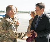 t. Col. Cary Mittelmark, 524th Special Operations Squadron commander, presents a Florida State University t-shirt and squadron coin