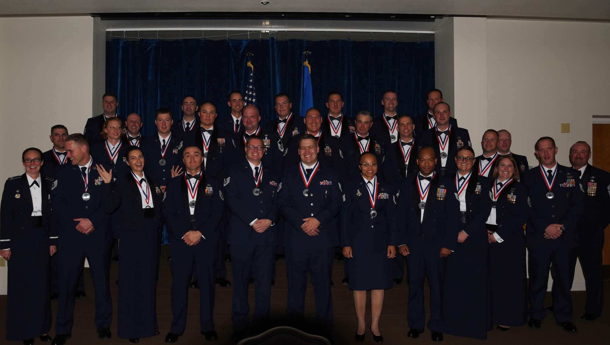 Col. Stacy Huser, 90th Missile Wing commander, and Chief Master Sgt. Kristian Farve, 90th MW command chief, pose for a photo with the bases newest senior non-commissioned officer corps inductees during a ceremony at the Trail’s End Event Center on F.E. Warren Air Force Base, Wyo., Oct. 13, 2017. Some of the inductees already sewed on the rank of master sergeant, while the majority will promote over the next year. (U.S. Air Force photo by Braydon Williams)