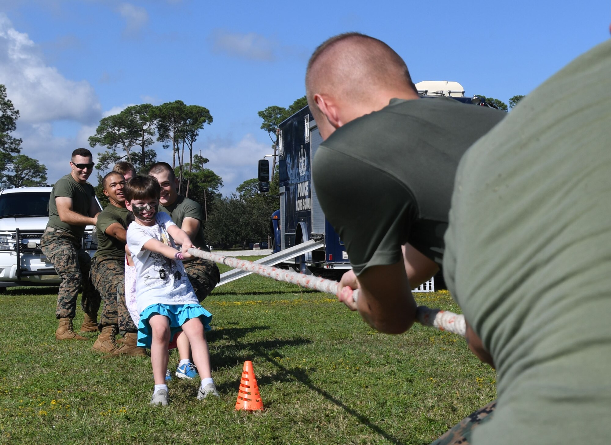 Maddison Niehus, daughter of Staff Sgt. Lisa Niehus, 81st Medical Group instructor, joins Keesler Marine Detachment Marines in a round of tug-of-war during Operation Hero Oct. 14, 2017, on Keesler Air Force Base, Mississippi. The event was designed to help children better understand what their parents do when they deploy. (U.S. Air Force photo by Kemberly Groue)