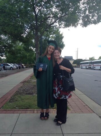 Yvette Morhee, 14th Airlift Squadron unit program coordinator, stands with Savannah Christopher, one of Morhee’s foster daughters during a high school graduation ceremony at Dutch Fork High School, Irmo, S.C., June 4, 2015.