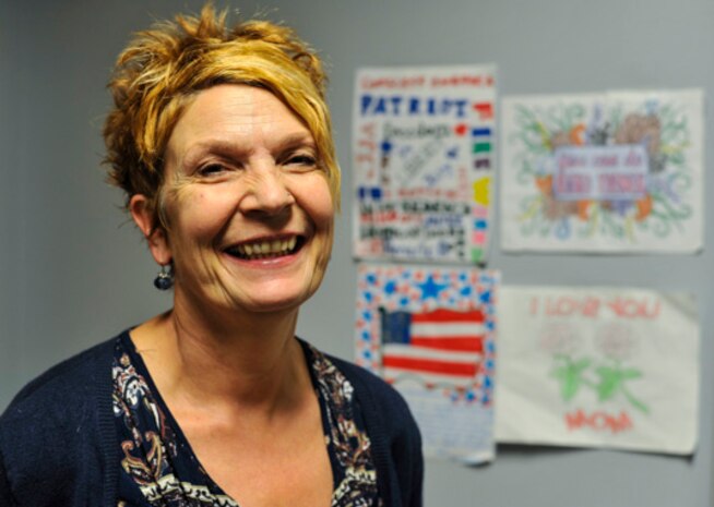 Yvette Morhee, 14th Airlift Squadron unit program coordinator, smiles in front of her children’s artwork at Joint Base Charleston, S.C., Oct. 12, 2017.