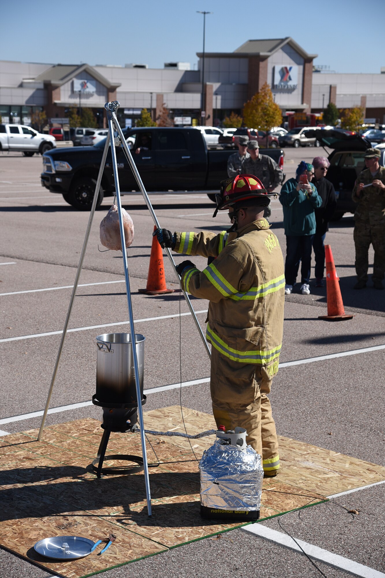 Tech. Sgt. Matthew Zakrajsek demonstrates what will happen when an unprepared turkey is placed in a deep fat fryer during a demonstration at the Base Exchange on Peterson Air Force Base, Colorado, Oct. 13, 2017. The event was part of Fire Safety Week. (U.S. Air Force photo by Robb Lingley)