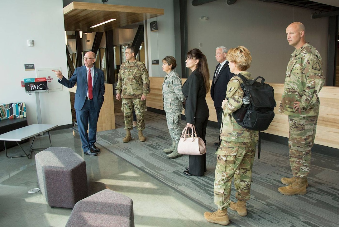 Charles Ambrose, left, president of the University of Central Missouri, leads a tour of the university’s new Missouri Innovation Campus for members and employees of the Missouri National Guard.