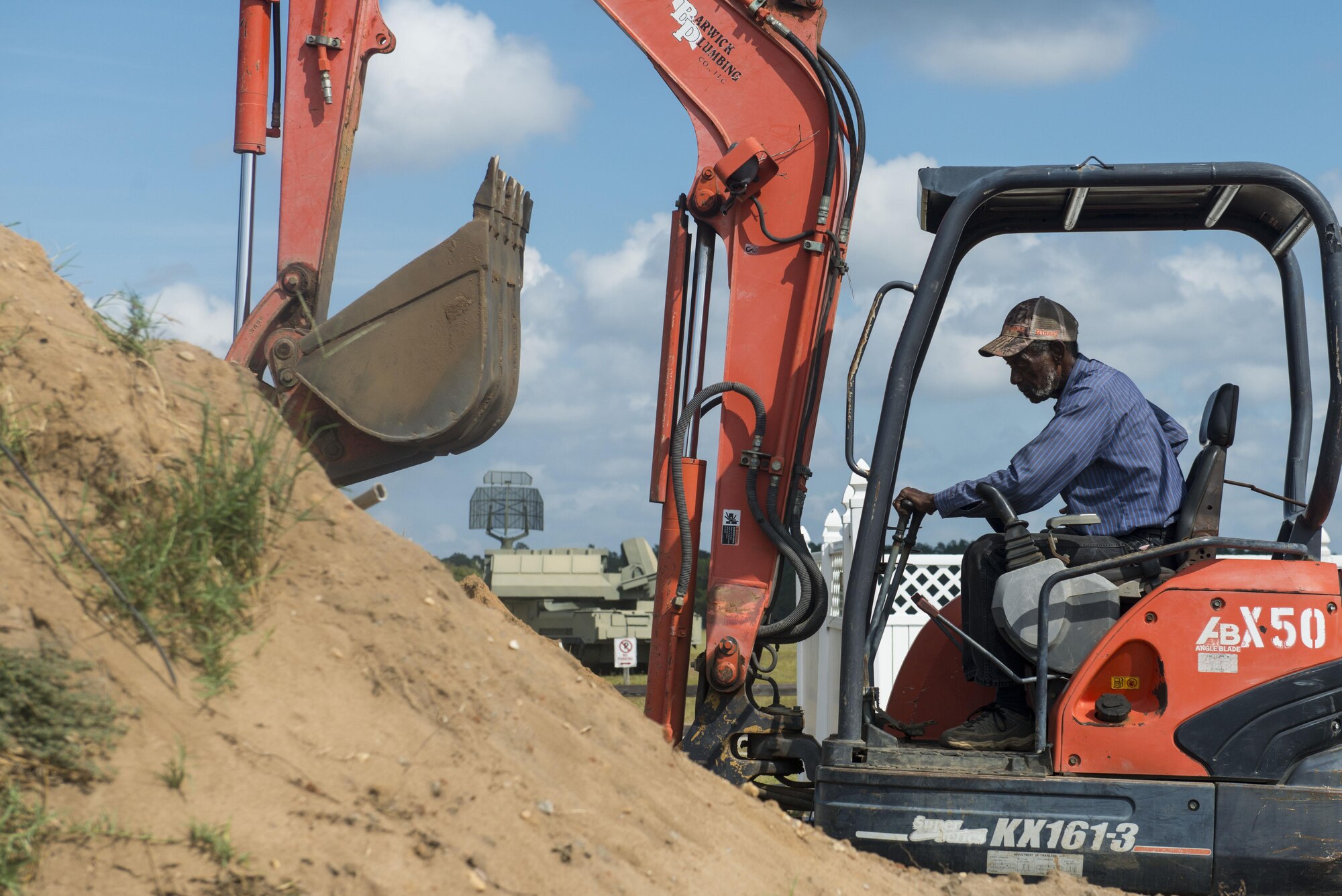 Selvin Nelson, contractor, uses an excavator to prepare the ground for water and sewer line placement at Poinsett Electronic Combat Range, near Wedgefield, S.C., Oct. 11, 2017.