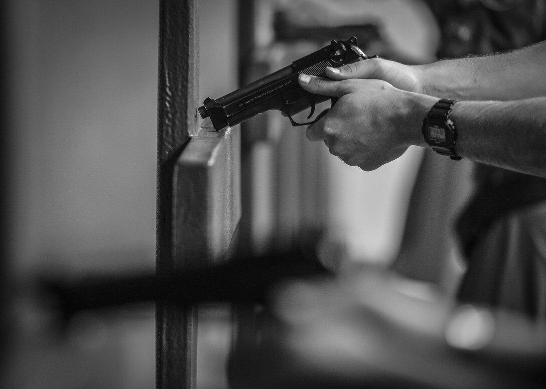 An Airmen assigned to the 56th Fighter Wing rests their M9 pistol on a barrier at the Combat Arms Training and Maintenance range at Luke Air Force Base, Ariz., Sept. 22, 2017. On average, CATM qualifies 50 to 70 Airmen per month on weapons such as the M9 pistol, M4 carbine, M203 grenade launcher, M240 Bravo and the M249 machine gun. (U.S. Air Force photo/Airman 1st Class Caleb Worpel)