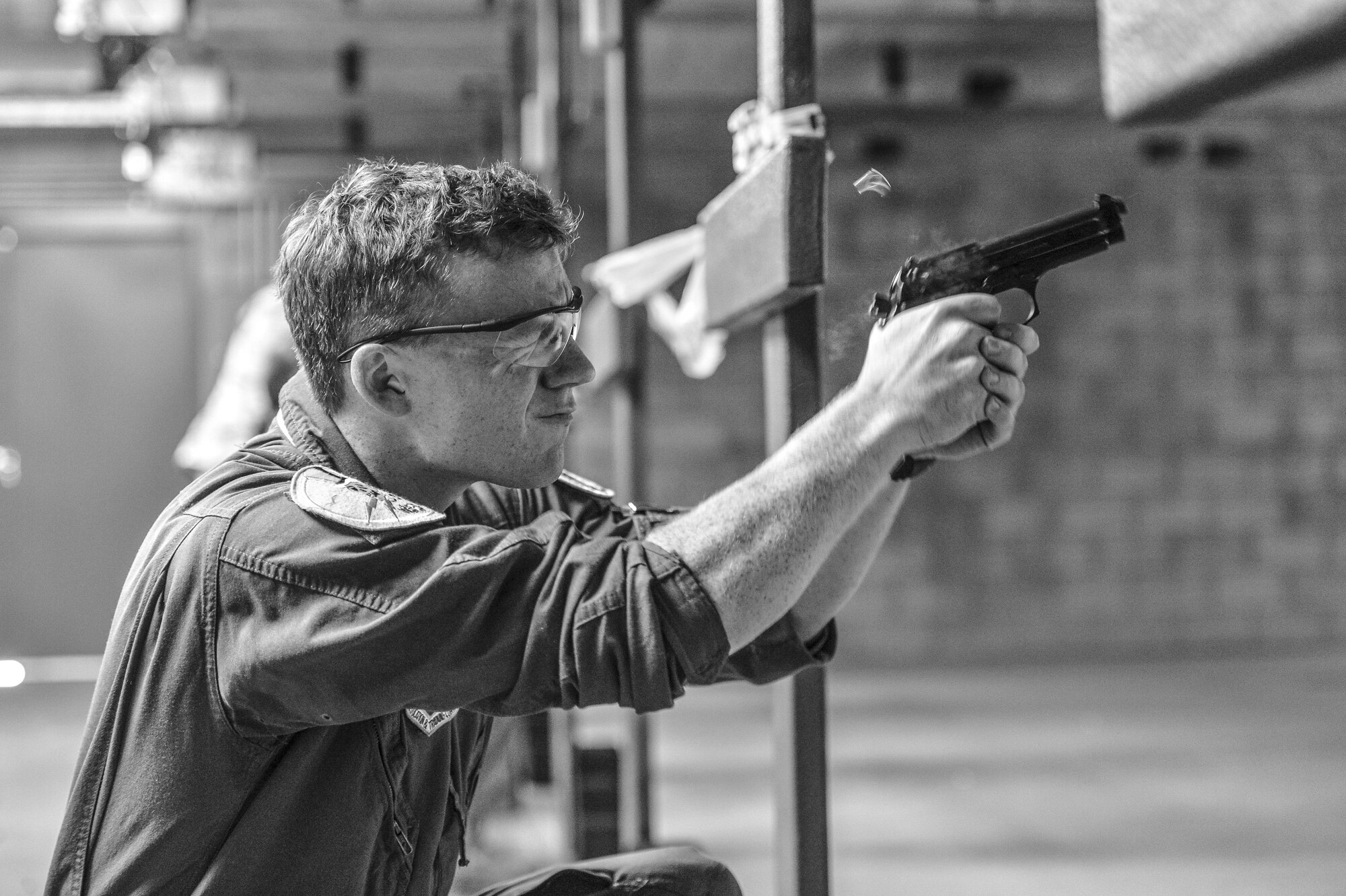 1st Lt. Drew Nash, 310th Fighter Squadron student pilot, fires his M9 pistol during a qualification course at the Combat Arms Training and Maintenance range at Luke Air Force Base, Ariz., Sept. 22, 2017. Nash and other Airmen participated in the course to ensure they possess the skills to properly maintain and fire a weapon. (U.S. Air Force photo/Airman 1st Class Caleb Worpel)