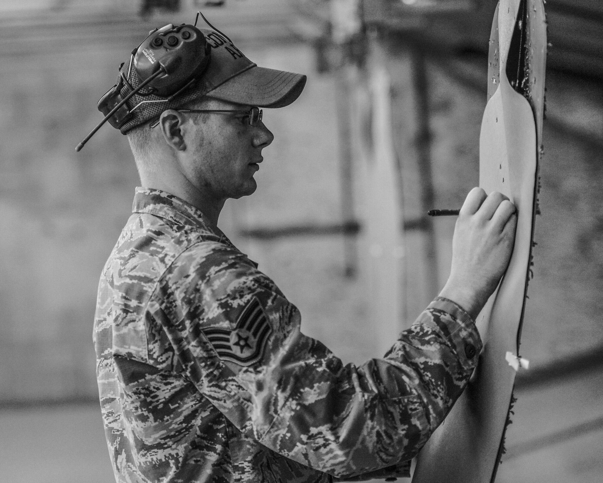 Staff Sgt. Nathaniel McNutt, 56th Security Forces Squadron Combat Arms instructor, checks a target for accuracy at Luke Air Force Base, Ariz., Sept. 22, 2017. McNutt and other instructors train students not only on the firing range, but also in the classroom focusing on mechanical features, characteristics, familiarizations, weapon effectiveness, ammunition types and specific firing positions. (U.S. Air Force photo/Airman 1st Class Caleb Worpel)