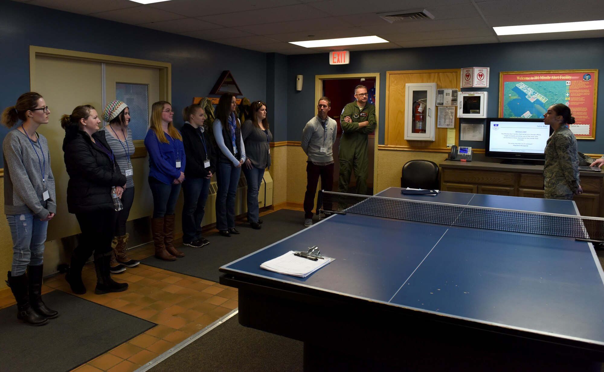 Airman 1st Class Seande Goodhue, far right, 341st Force Support Squadron missile chef, briefs spouses during a tour at a missile alert facility Oct. 14, 2017, at Malmstrom Air Force Base, Mont. During the tour, spouses received a mission brief, toured the missile procedures trainer and finished with a visit to a missile alert facility in the missile field. (U.S. Air Force photo/Tech. Sgt. Caleb Pierce)