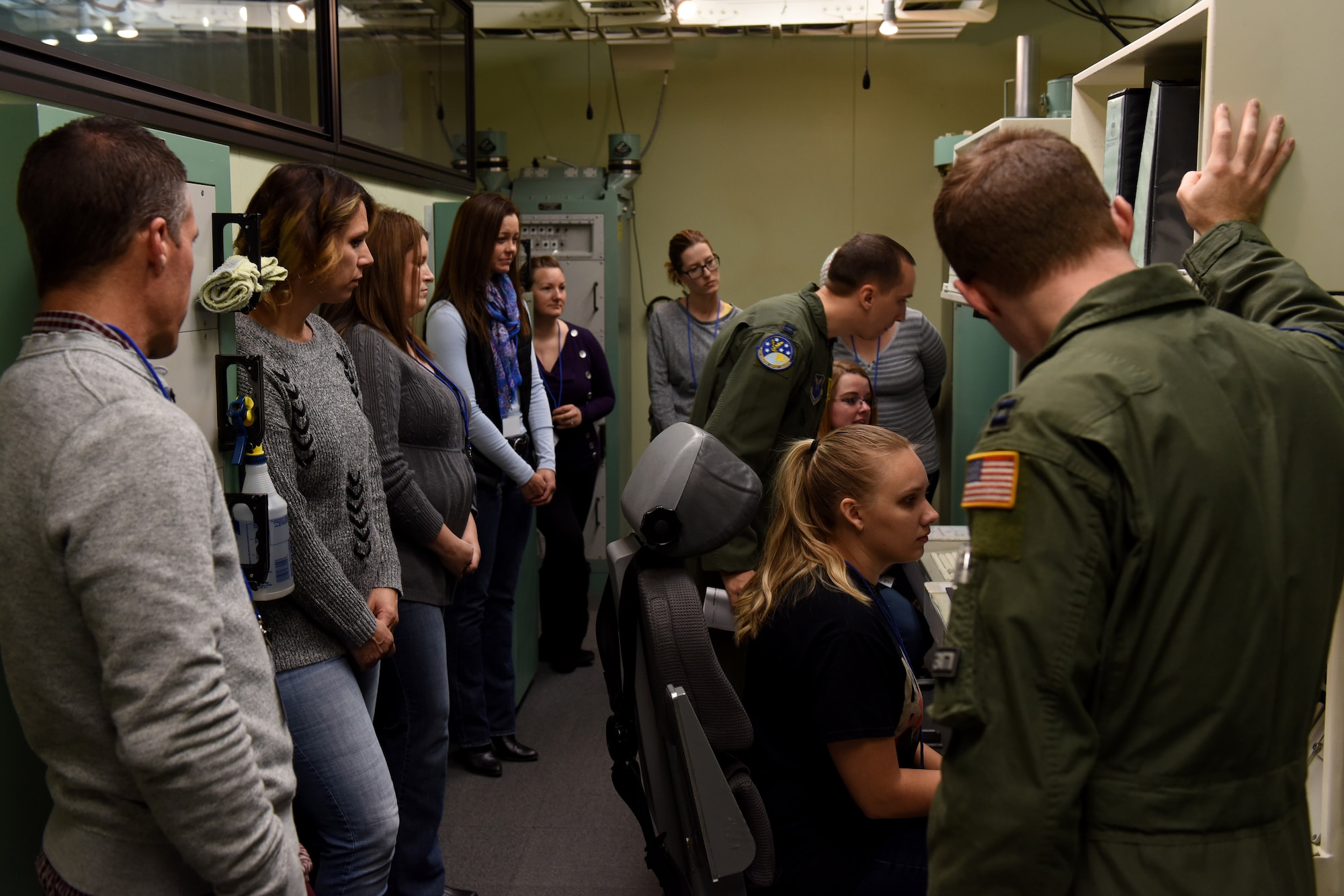 Capt. Ross Millard, 341st Operations Support Squadron weapons and tactics assistant director of operations, runs spouses through simulated training in the missile procedures trainer during a tour Oct. 14, 2017, at Malmstrom Air Force Base, Mont. The missile procedures trainer allows missileers to train and practice scenarios they might experience in the missile field. (U.S. Air Force photo/Tech. Sgt. Caleb Pierce)