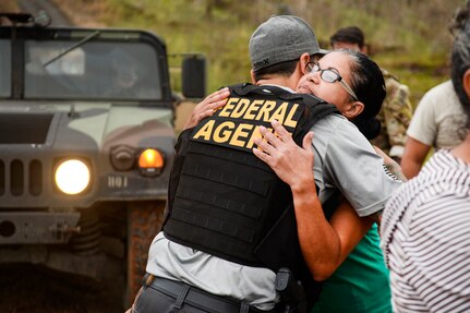Two people hug.