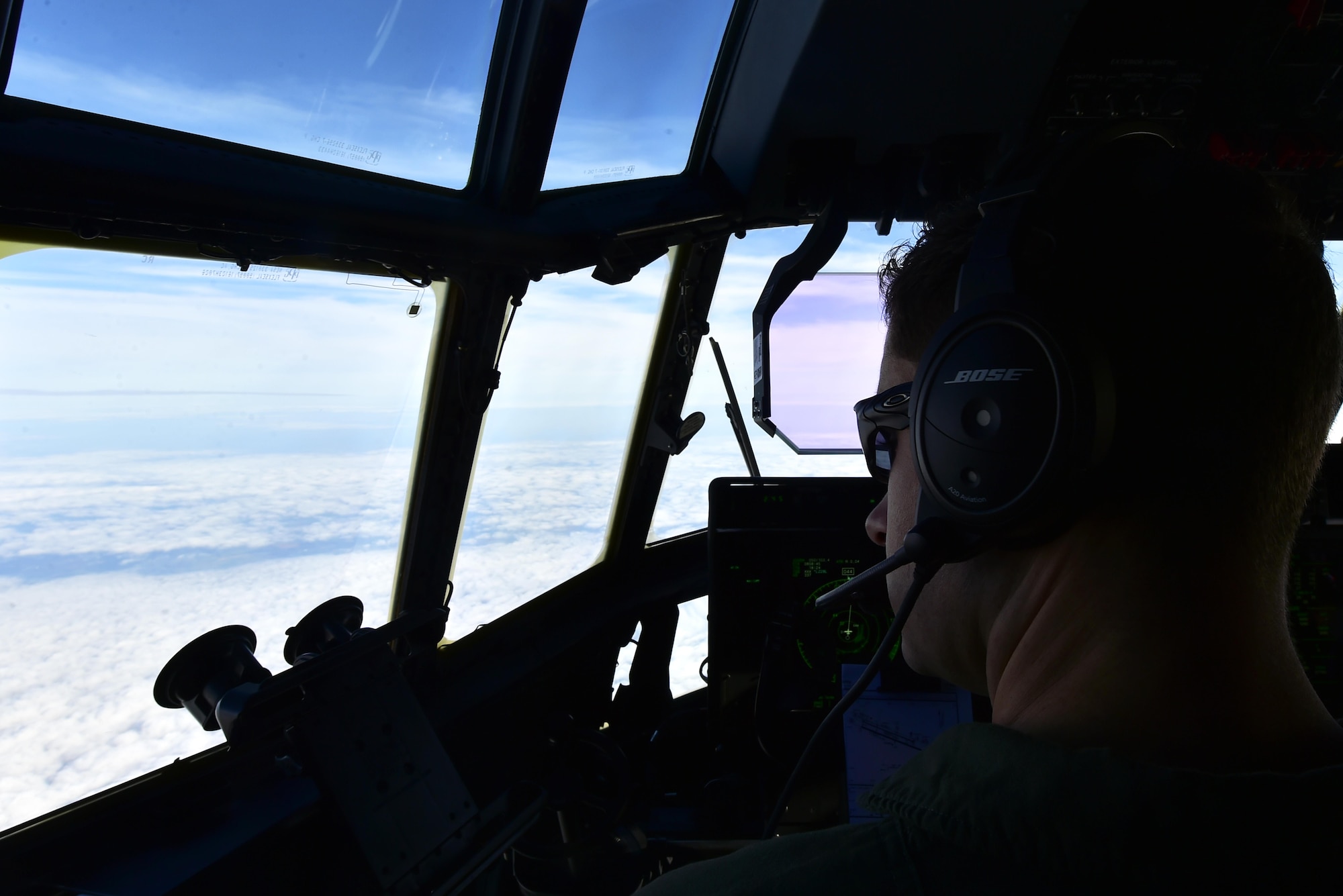 U.S. Air Force Capt.Christopher Freed, 37th Airlift Squadron pilot, stares out the cockpit of a C-130J Super Hercules while flying from Ramstein Air Base, Germany, to Powidz AB, Poland, Oct. 13, 2017. Airmen assigned to the 86th Airlift Wing flew to Poland for the latest iteration of Operation Atlantic Resolve, a NATO-led training operation between the U.S. Air Force and Polish Air Force. (U.S. Air Force photo by Staff Sgt. Jonathan Bass)