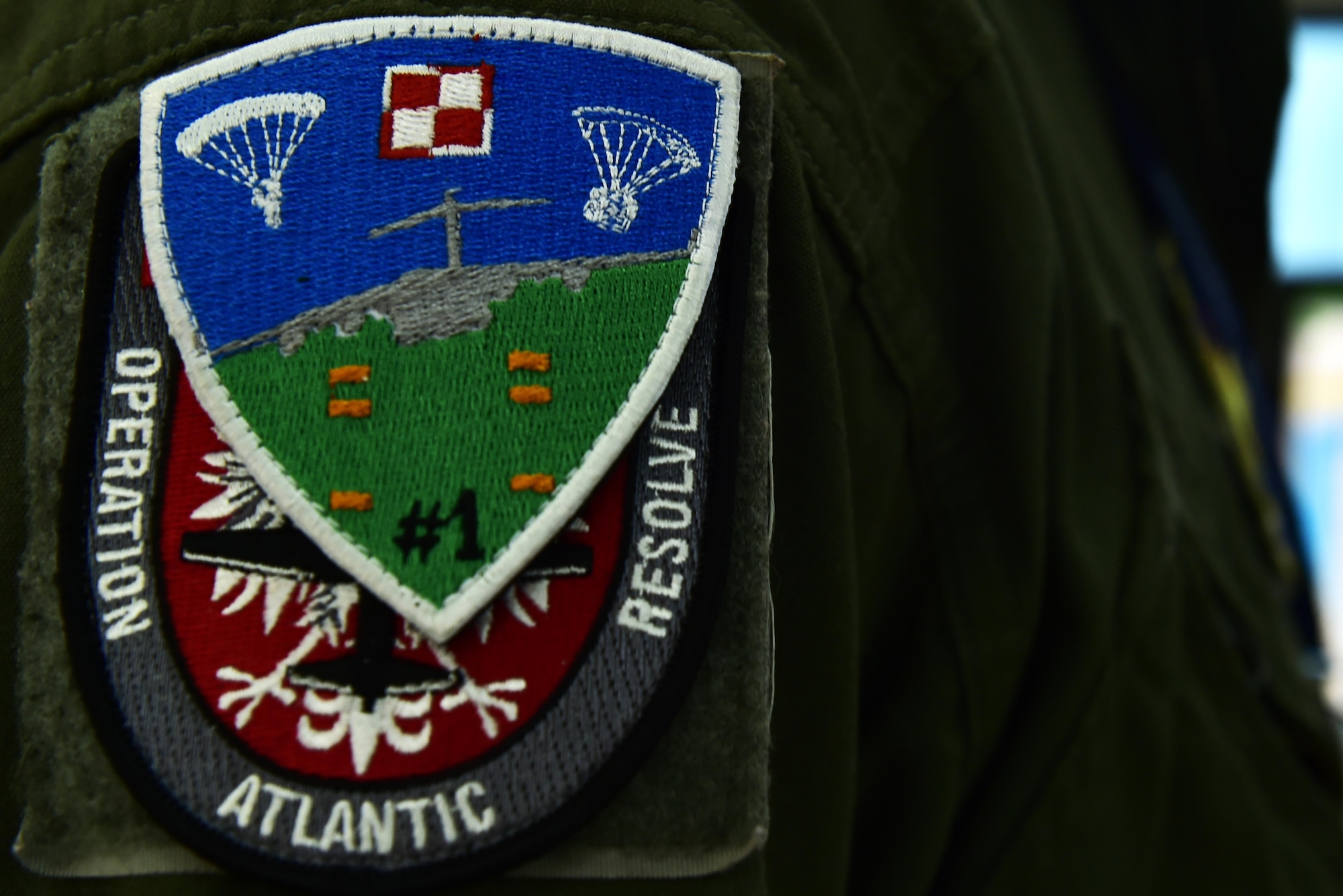 U.S. Air Force Capt. Jonathan Hansen, 37th Airlift Squadron pilot and Operation Atlantic Resolve mission commander, wears a Polish Air Force patch over his OAR patch on Powidz Air Base, Poland, Oct. 16, 2017. The mission of OAR is to enhance interoperability while simultaneously maintaining regional security with the Polish Air Force. (U.S. Air Force photo by Staff Sgt. Jonathan Bass)