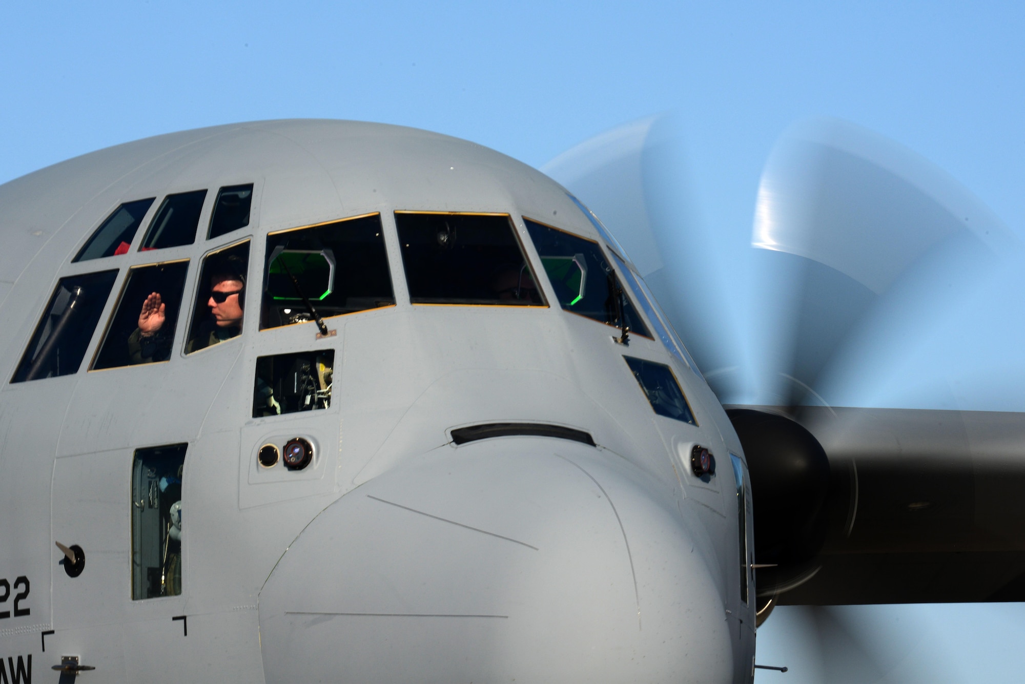 A U.S. Airmen assigned to the 37th Airlift Squadron returns a salute from his crew chief before departing Powidz Air Base, Poland, on a familiarization flight during Operation Atlantic Resolve, Oct. 16, 2017. Airmen flew four C-130 Hercules’ around the OAR Area of Responsibility to begin familiarizing themselves with the terrain, as well as the how the different aircraft fly in formation. (U.S. Air Force photo by Staff Sgt. Jonathan Bass)