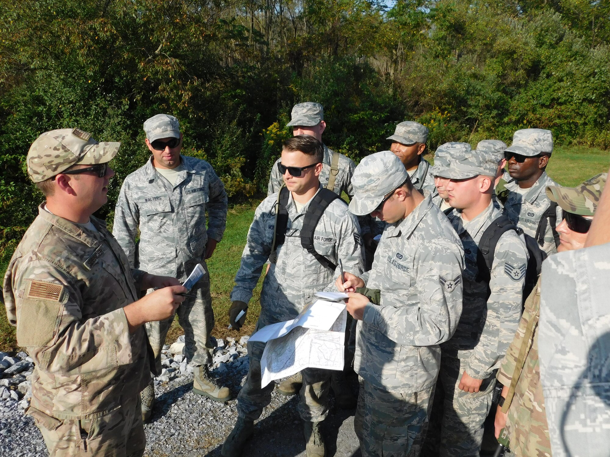 Staff Sgt. William Spencer, 436th Civil Engineer Squadron explosive ordnance disposal NCO in charge of training, instructs land navigation to other civil engineers Sept. 21, 2017, during a field training exercise at Fort Indiantown Gap, Pa. Air Force civil engineers establish bare-bases and runways in austere locations, maintaining infrastructure and providing security for their assets. (Courtesy photo)