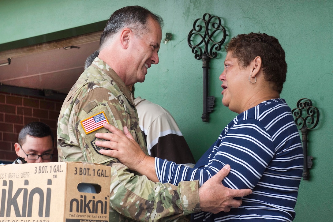 Brig. Gen. Jose Rayes, commander, Joint Task Force Puerto Rico Dual Status, greets a resident.