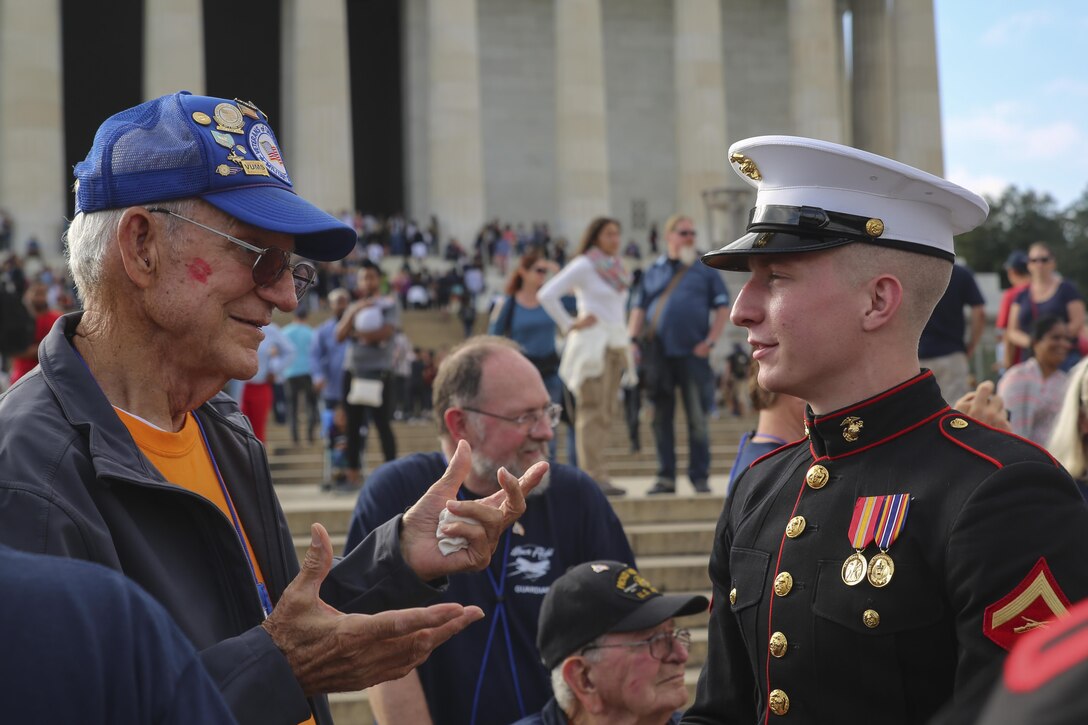 Lance Cpl. Maxwell Posey, member of the U.S. Marine Corps Silent Drill Platoon, speaks with a veteran of Old Glory Honor Flight Northeast Tennessee, after the performance at the Lincoln Memorial, Washington D.C., Oct. 14, 2017. Old Glory Honor Flight is dedicated to transporting local WWII and Korean War veterans to visit memorials built to honor those service members who fought for our country. (Official Marine Corps photo by Lance Cpl. Damon Mclean/Released)