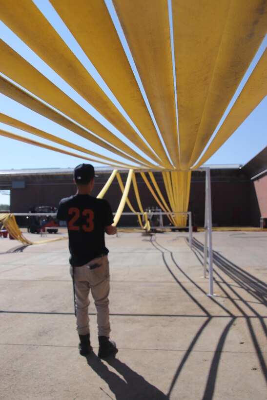 “Historic” is the word for this year’s Wildland fires.  Now supplies are coming back to be refurbished and made ready to battle the next incident.  Rocky Mountain Interagency Support Cache Materiel Handler, Damion Diaz, is pulling DLA supplied host that’s been tested, washed, and dried and ready to fight fires.