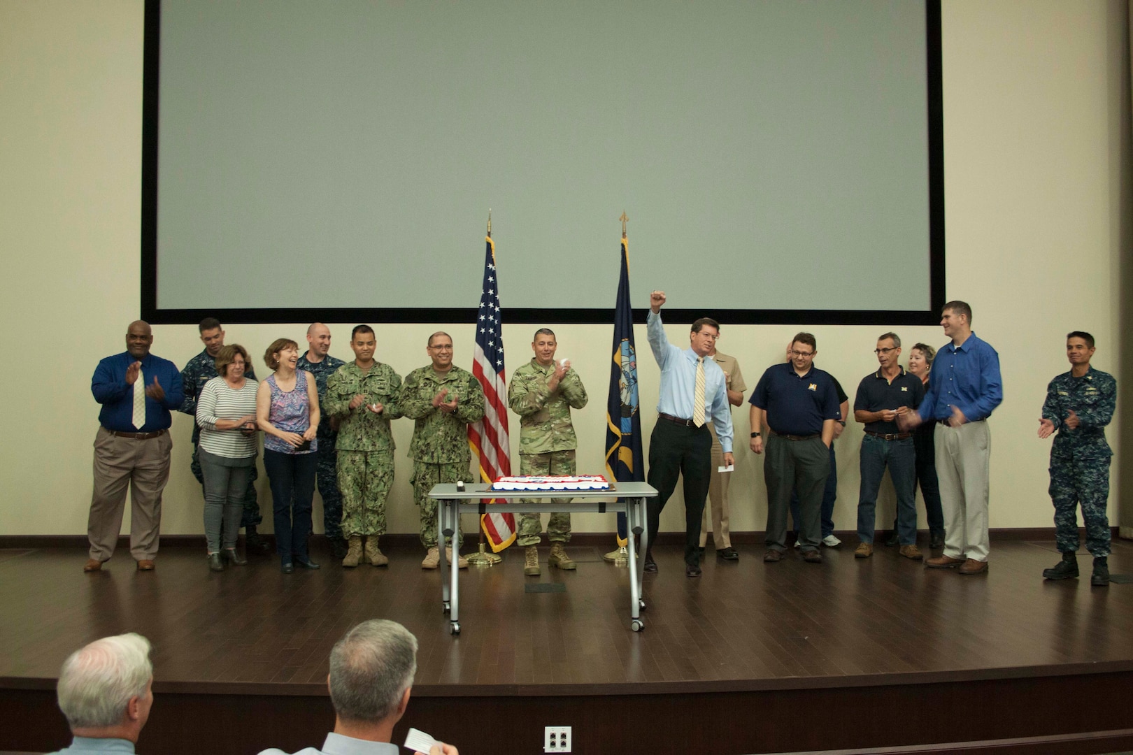 DLA Distribution commander Army Brig. Gen. John S. Laskodi, center, sings the Navy song in honor of the Navy’s 242nd birthday alongside DLA Distribution’s active, reserve and retired Navy sailors.