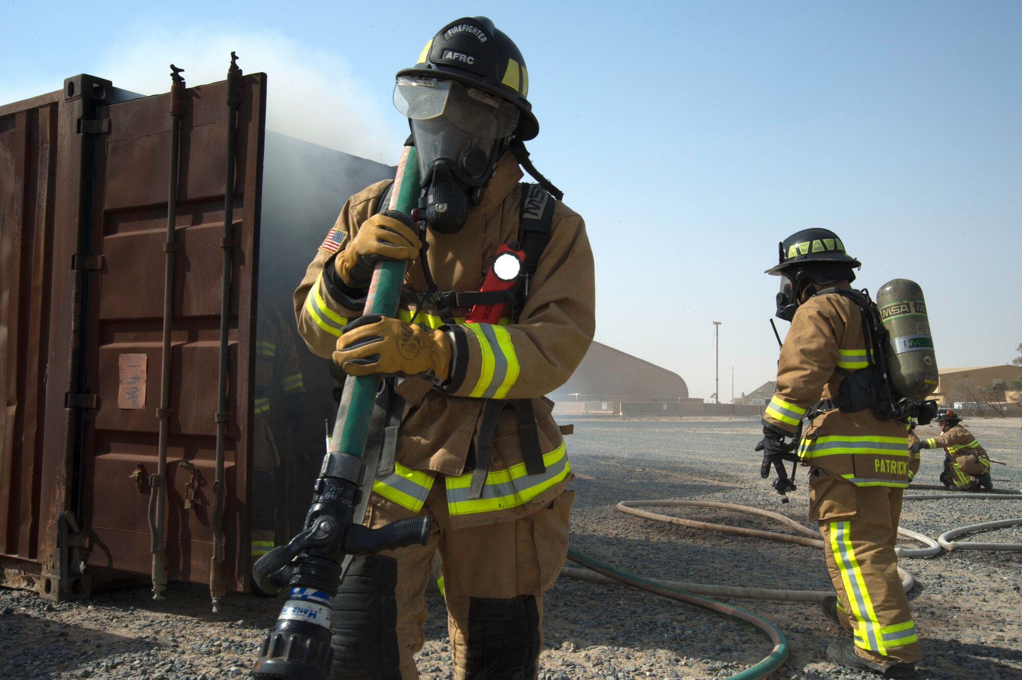 A fire fighter from the 386th Expeditionary Civil Engineer Squadron Fire Department exit's a live fire training facility at an undisclosed location in Southwest Asia, Oct. 20, 2017. The training was a coordinated effort with various units on base to ensure Airmen's safety was upheld and mission capability was not interrupted. (Air Force photo by Staff Sgt. William Banton)