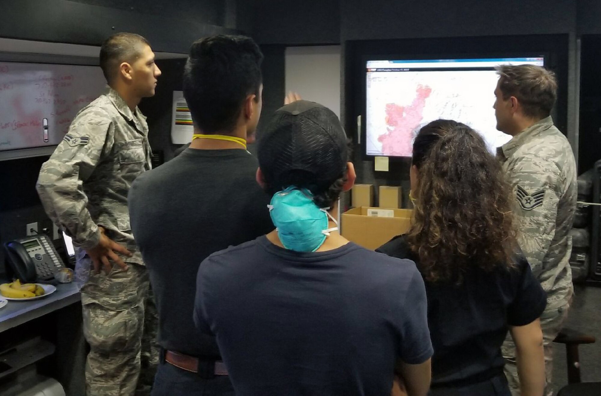 California Air National Guard Airman 1st Class David Ramirez, left, and Staff Sgt. Tyler Crumpton, right, show updated fire maps to evacuees at Napa Valley College in Napa, California, inside a Mobile Emergency Operations Center (MEOC) from the Cal Guard's 163d Attack Wing at March Air Reserve Base, California, Oct. 13, 2017. In addition to sharing updated fire information, the MEOC staff also established wireless internet access and a cell phone network for evacuees who took up shelter in the college gymnasium after a series of wildfires burned through California's wine country. (U.S. Air National Guard photo by Staff Sgt. Hideyoshi Izumi)