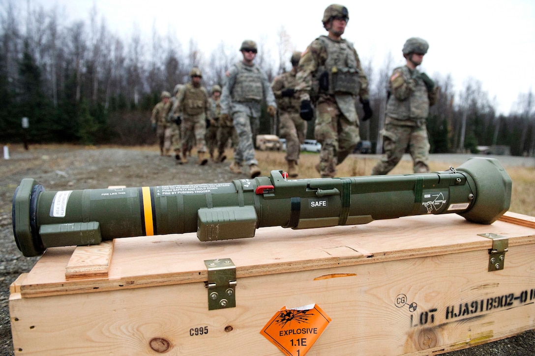 Soldiers walk to the firing line before conducting M136E1 AT4-CS light anti-armor rocket launcher during live-fire training.