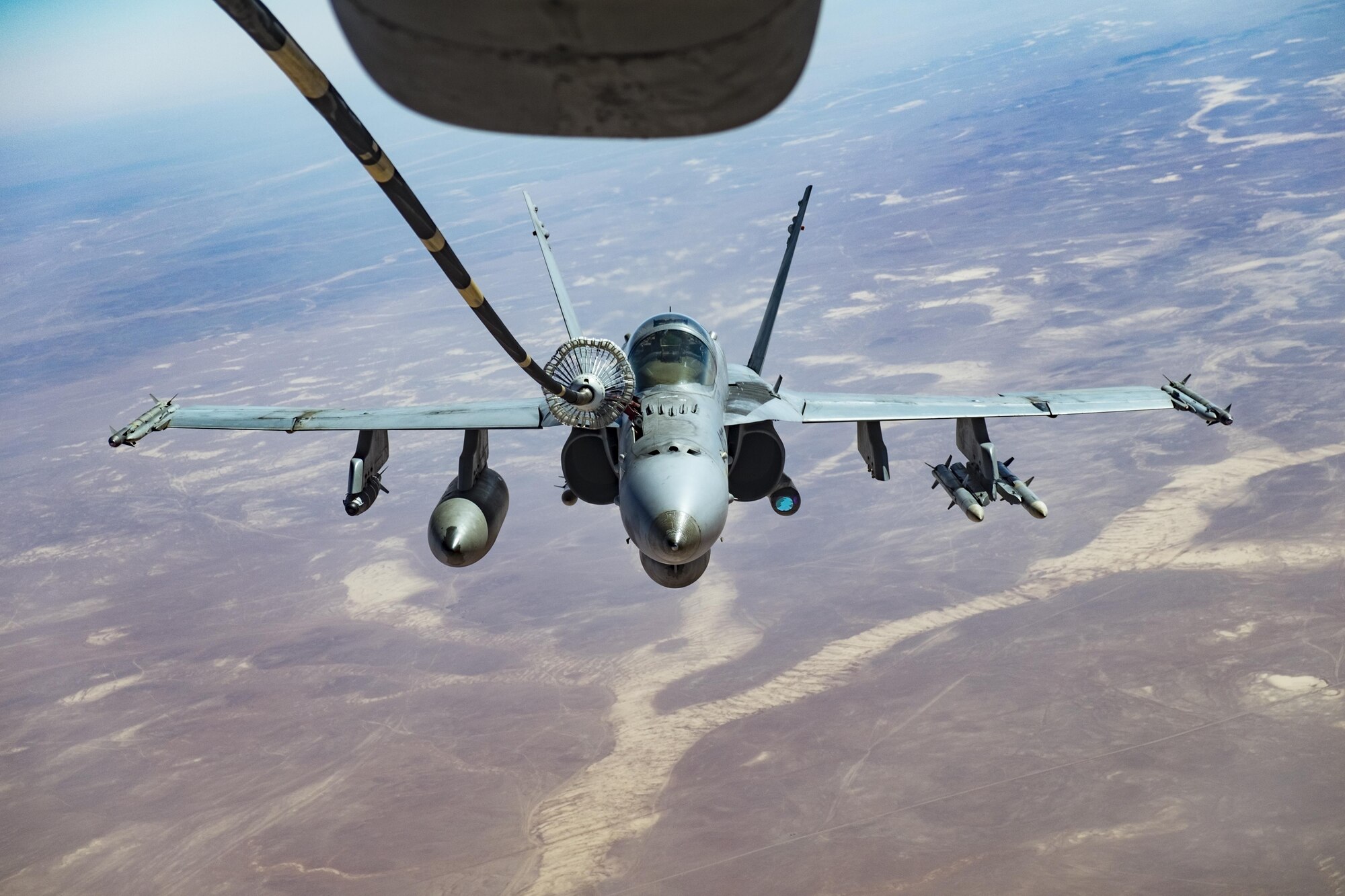 An F/A-18C Super Hornet receives fuel from a KC-10 Extender with the 908th Expeditionary Air Refueling Squadron, Oct. 9, 2017, above southwest Asia. F/A-18C Super Hornet pilots with the strike group conduct maritime security operations to reassure allies and partners, preserve freedom of navigation, and maintain the free flow of commerce. (U.S. Air Force photo by Staff Sgt. Preston Webb)