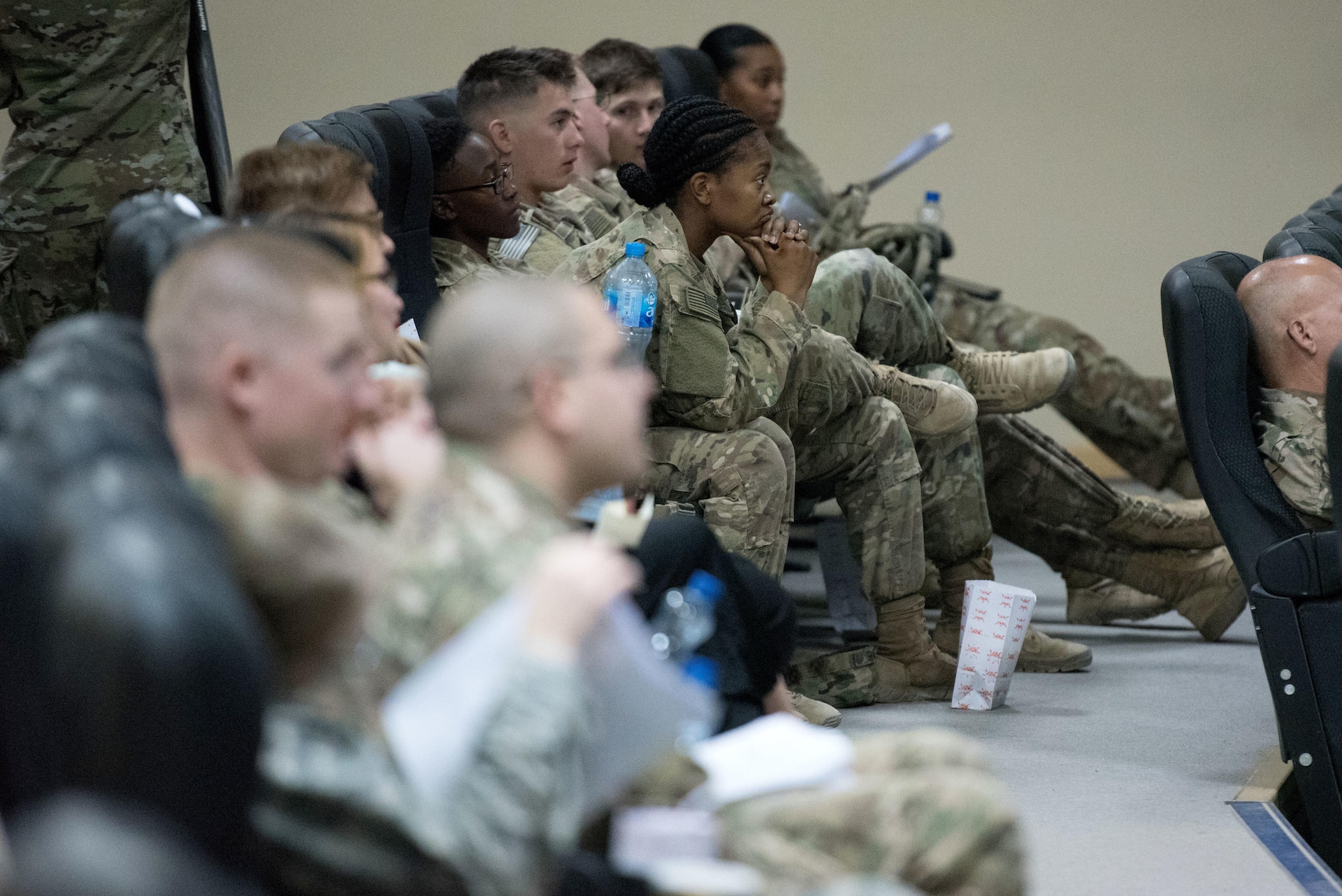 Soldiers seated in rows listening to seminar.
