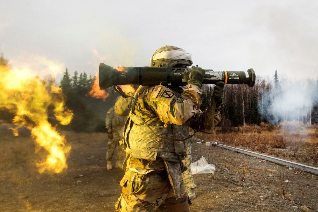 A soldier fires a M136E1 AT4-CS light anti-armor rocket launcher during live-fire training.