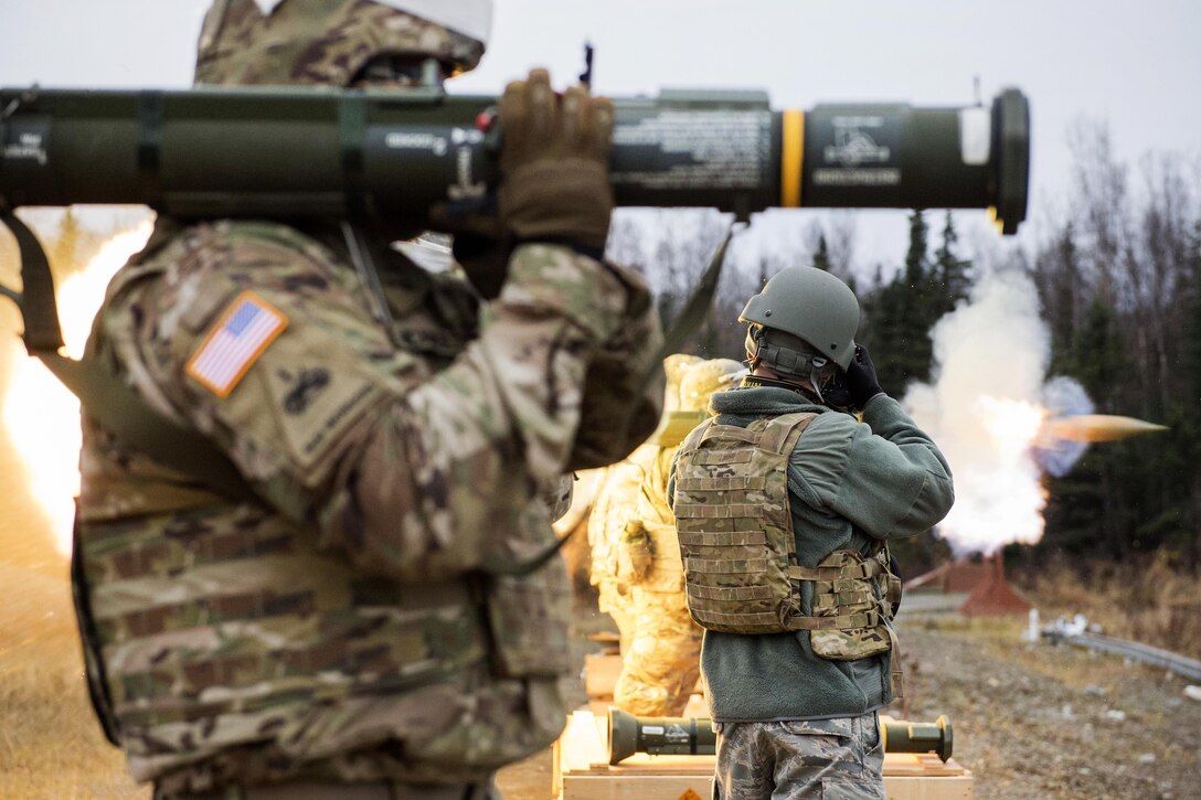 Staff Sgt. Westin Warburton, center, photographs soldiers conducting M136E1 AT4-CS light anti-armor rocket launcher live-fire.
