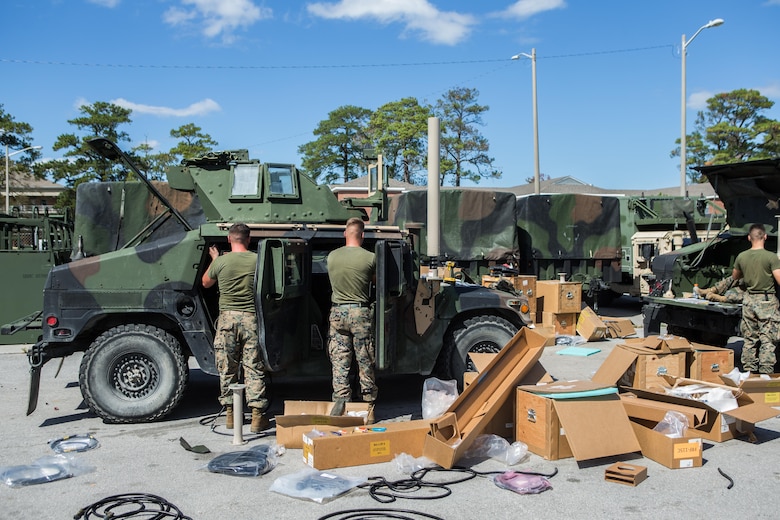 U.S. Marines with Battalion Landing Team 2nd Battalion, 6th Marine Regiment, 26th Marine Expeditionary Unit (MEU), upgrade a system on a high-mobility, multipurpose wheeled vehicle (HMMWV) at Camp Lejeune, N.C., Oct. 3, 2017.