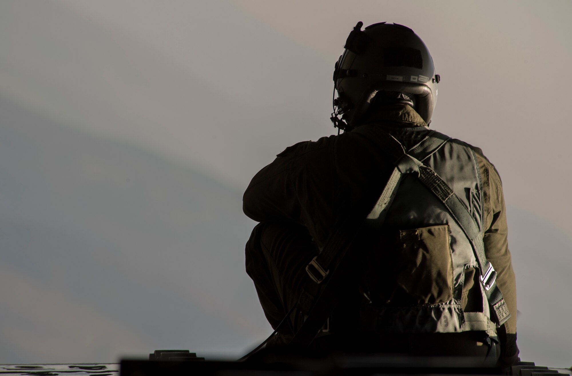 U.S. Air Force Tech. Sgt. Duane C. Jensen III, 37th Airlift Wing loadmaster, sits on the open ramp of a C-130J Super Hercules flying near Ramstein Air Base, Germany, Oct. 17, 2017. The 37th AS flew an incentive flight for participants of the Ramstein Airman and Family Readiness Center’s Heart Link program, which provides information and networking opportunities to military spouses. (U.S. Air Force photo by Senior Airman Tryphena Mayhugh)