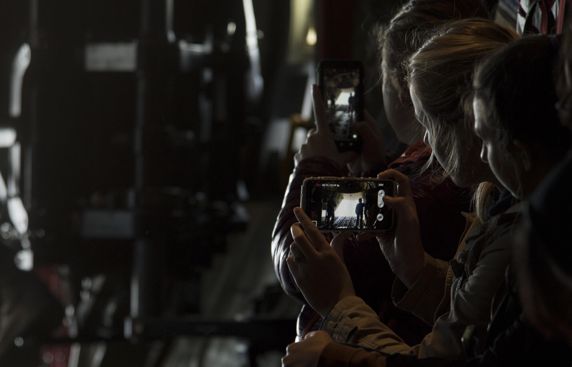 A Ramstein military spouse records a video of the ramp doors opening on a C-130J Super Hercules flying near Ramstein Air Base, Germany, Oct. 17, 2017. More than 25 military spouses participated in an incentive flight with the 37th Airlift Squadron as a part of the Ramstein Airman and Family Readiness Center’s Heart Link program. (U.S. Air Force photo by Senior Airman Tryphena Mayhugh)