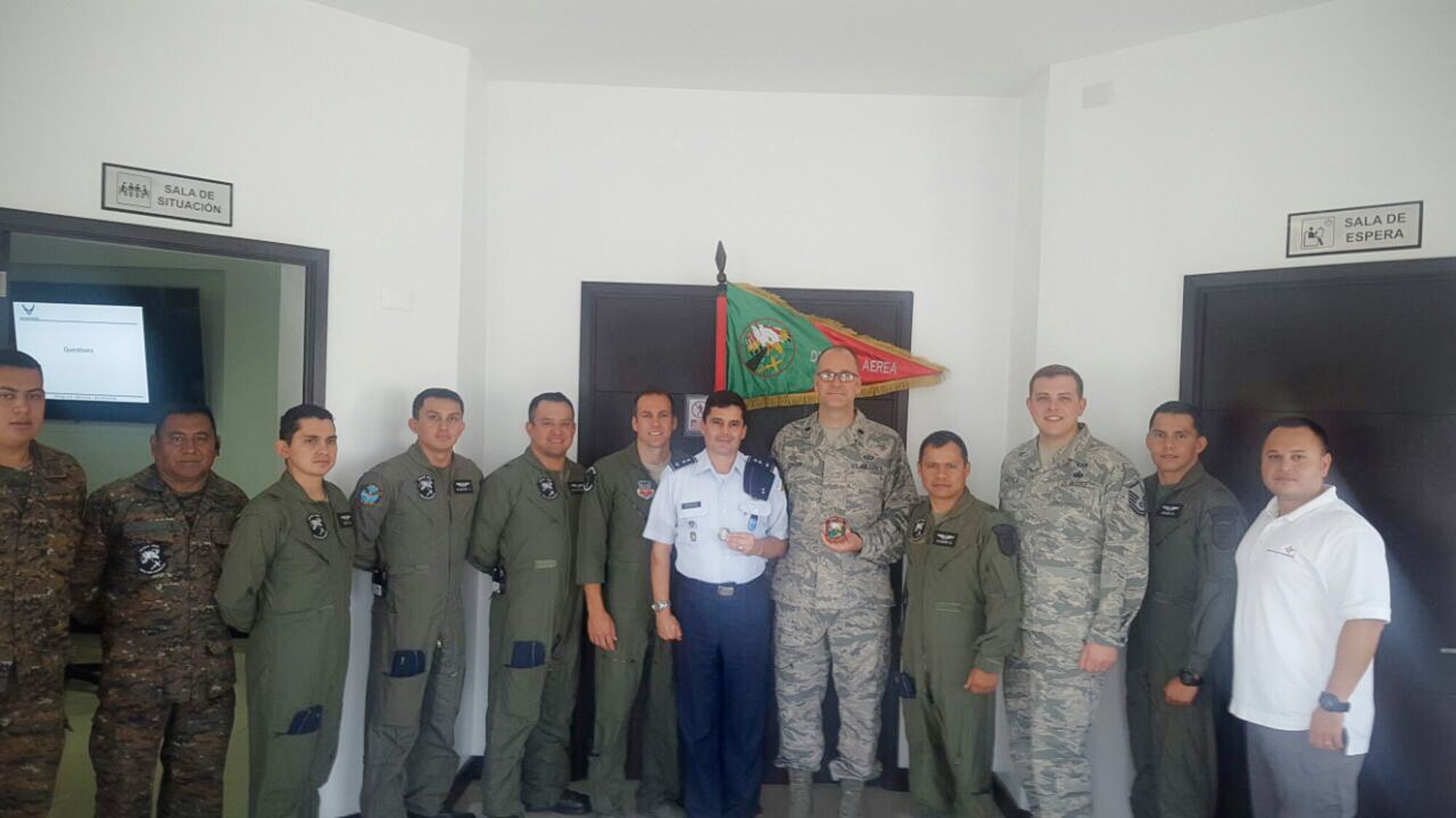The 225th Air Defense Squadron members exchange unit coins with the Guatemalan Air Force during their State Partnership Program visit to Guatemala Aug. 25, 2017.  The SPP links a state's National Guard with the armed forces of a partner country in a cooperative, mutually beneficial relationship by means of tailored, small footprint, high-impact security cooperation engagements that foster long-term enduring relationships with U.S. friends and allies around the world.  The SPP arose from a 1991 U.S. European Command decision to pair reserve component soldiers and airmen with the armed forces of the then newly formed nations of the Baltic Region following the collapse of the Soviet Bloc.