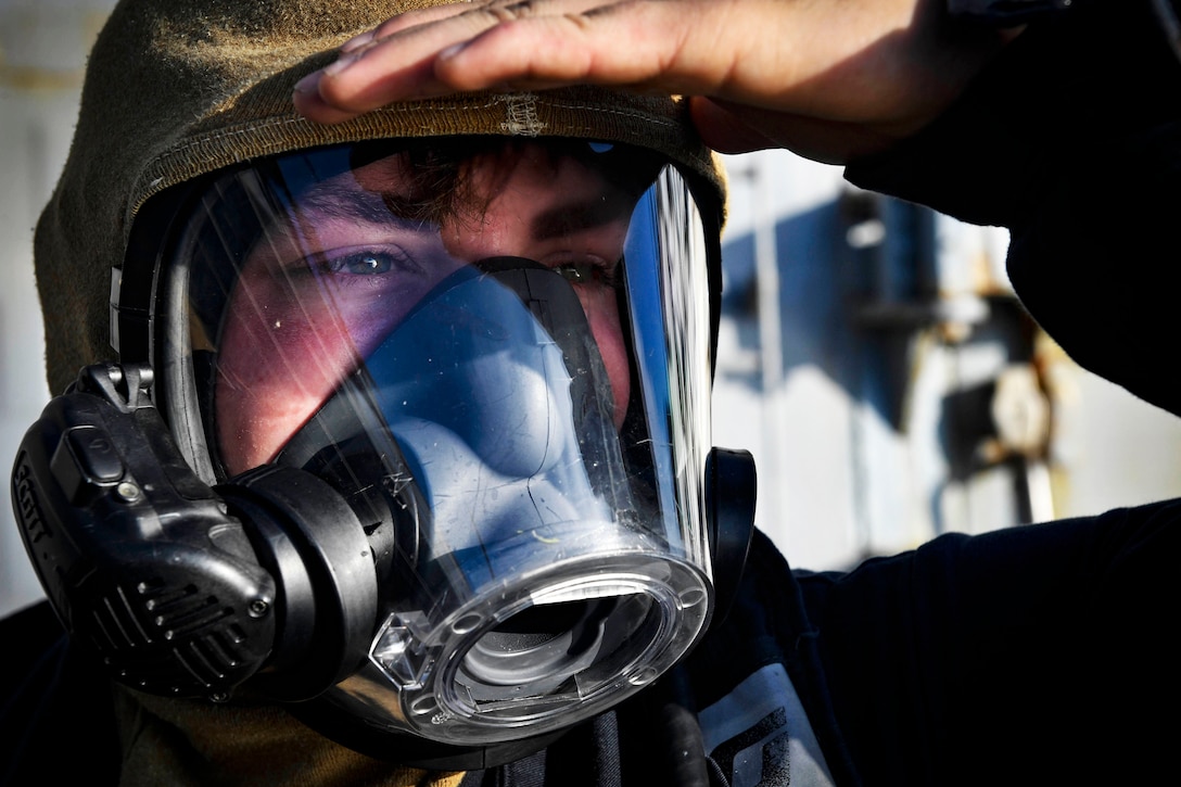 Seaman monitors a breathing apparatus.