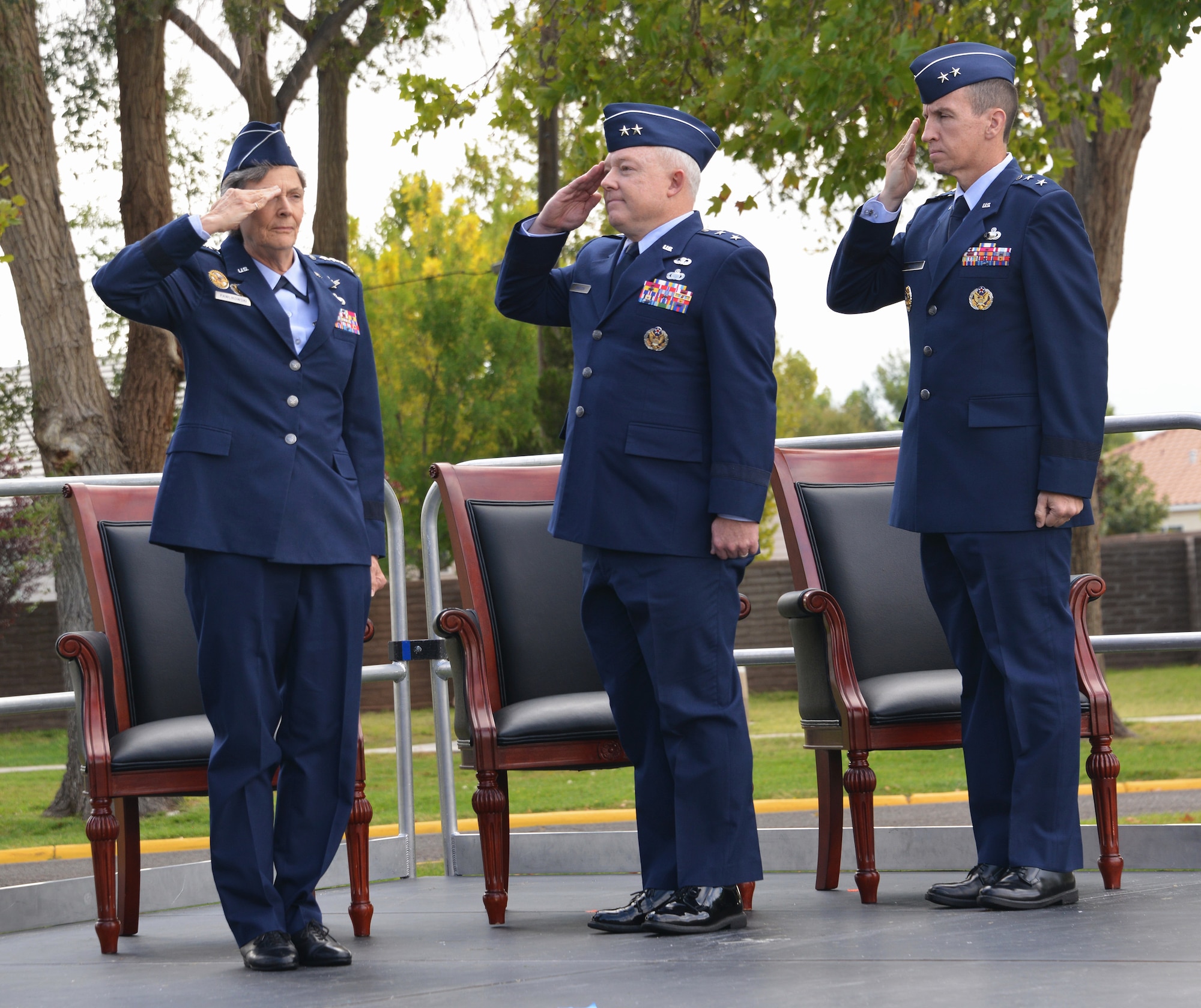 From left, Air Force Materiel Command Commander Gen. Ellen M. Pawlikowski, outgoing Air Force Nuclear Weapons Center Commander Maj. Gen. Scott Jansson and incoming AFNWC Commander Maj. Gen. Shaun Q. Morris salute during the change of command ceremony Friday at Hardin Field. Pawlikowski presided over the ceremony.